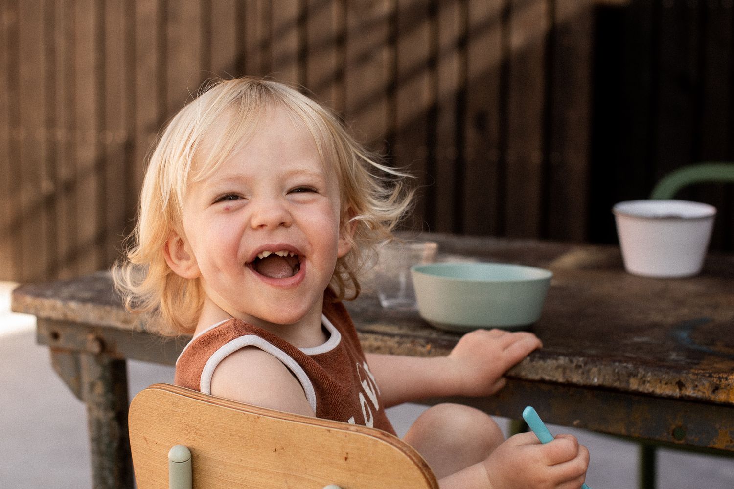 Candid moments captured at a rustic wooden table showing joyful expressions.