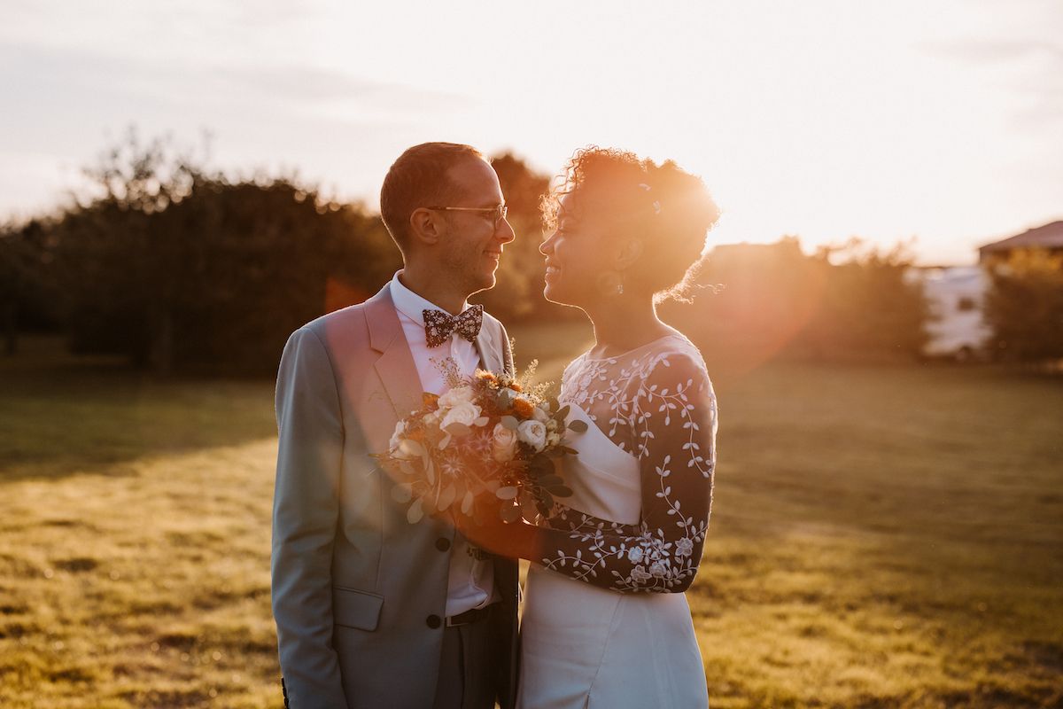 A romantic sunset wedding portrait with golden light filtering through.