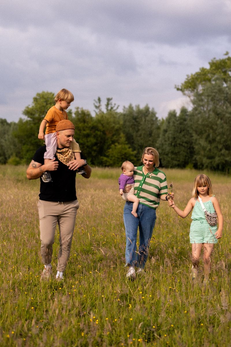 Group walking through a wildflower meadow on a cloudy summer day.