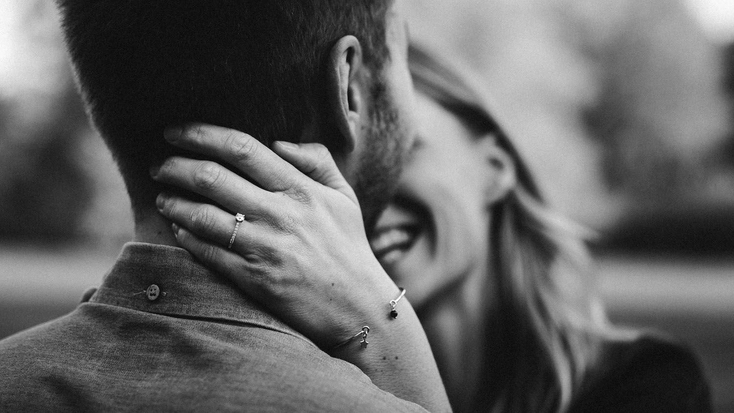 Black and white intimate portrait of couple sharing tender romantic moment.