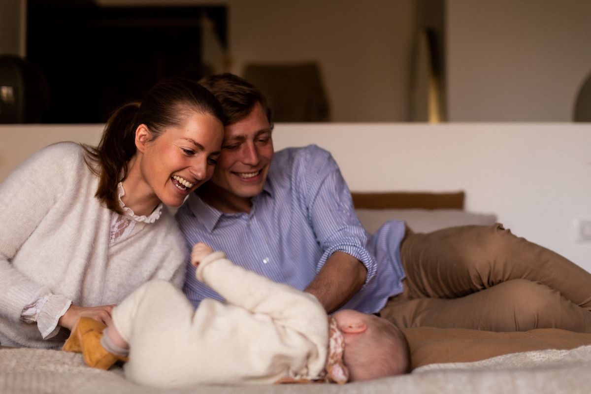 A tender family moment shared while relaxing together on a couch.