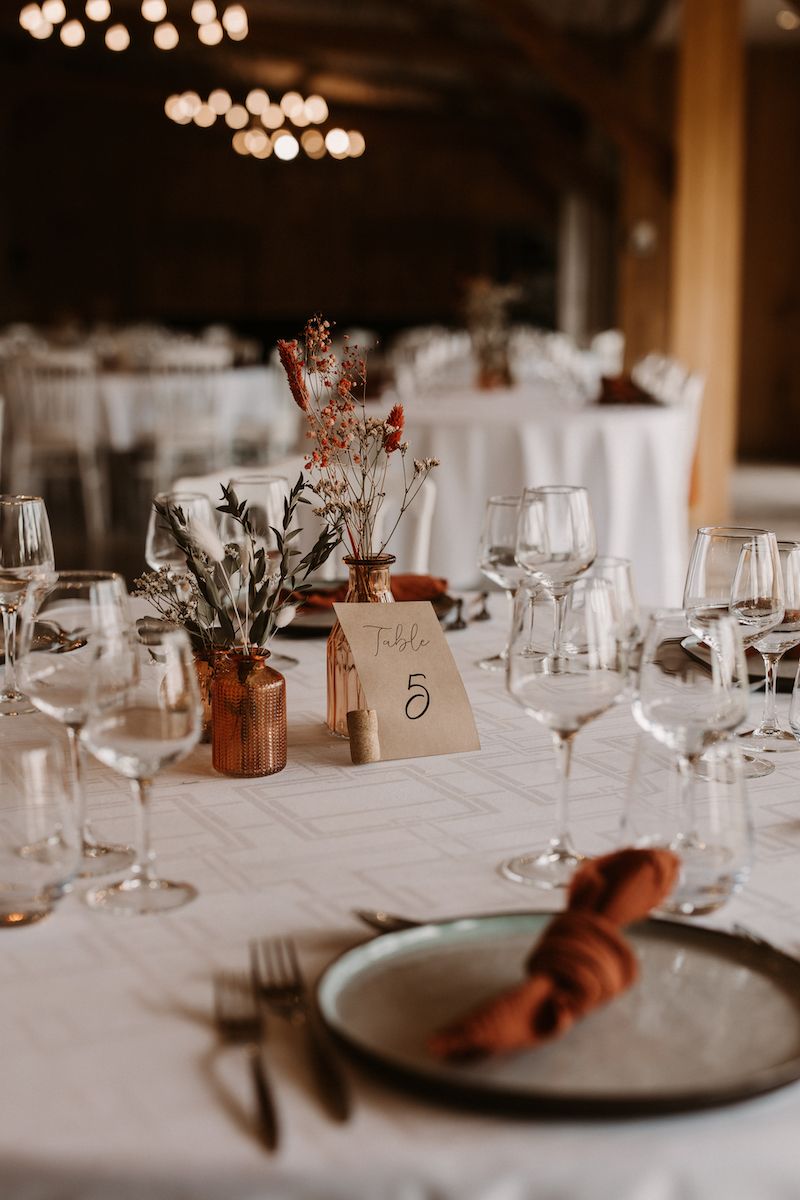 Elegant wedding reception table settings with soft lighting and minimalist decor.