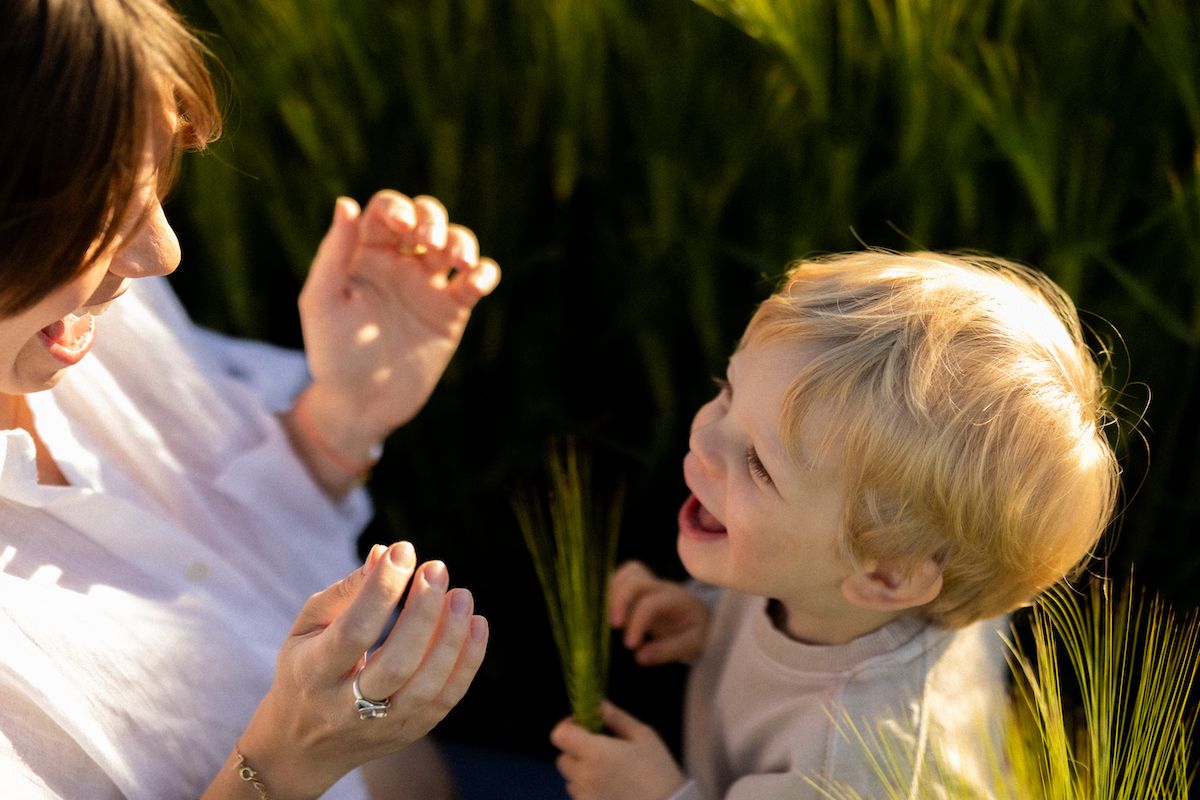 Playful moment shared in wheat field during golden hour.