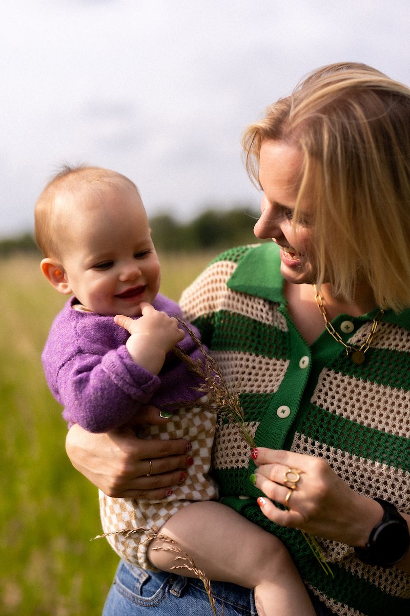Tender outdoor moments between parent and baby in a natural setting.