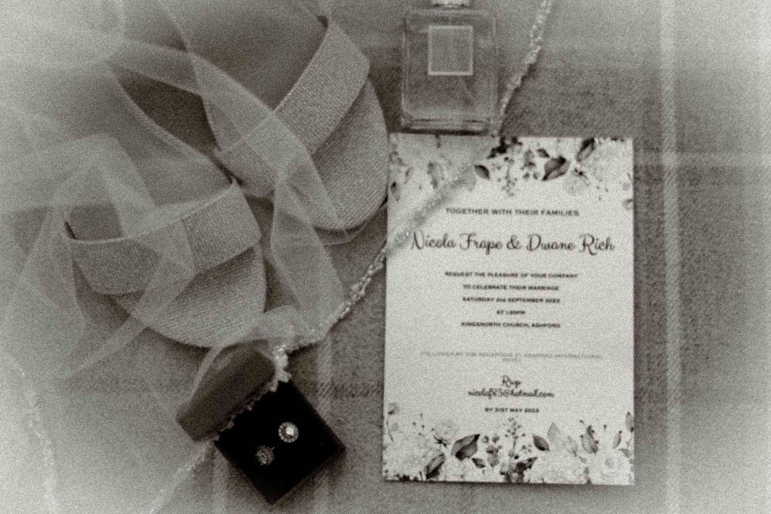 Wedding invitation with floral design displayed alongside decorative elements in black and white.