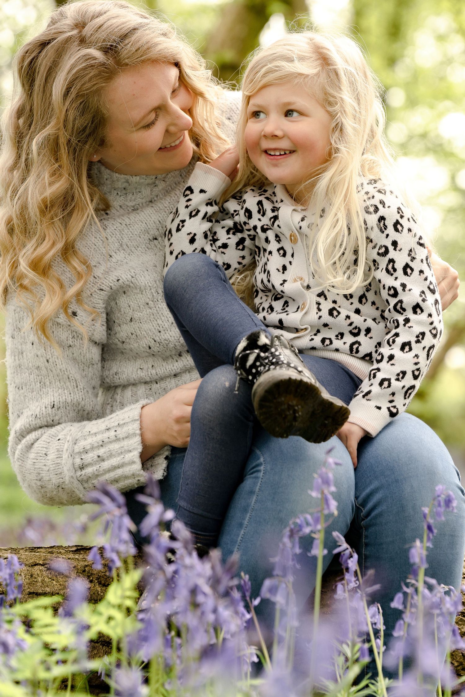 Candid outdoor portraits in a field of purple wildflowers on a sunny spring day.