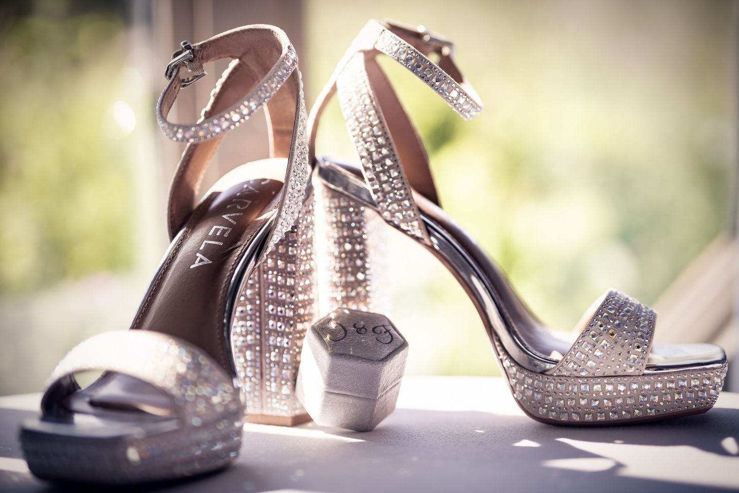 Sparkly bridal shoes arranged in an artistic row with soft bokeh lighting effects.