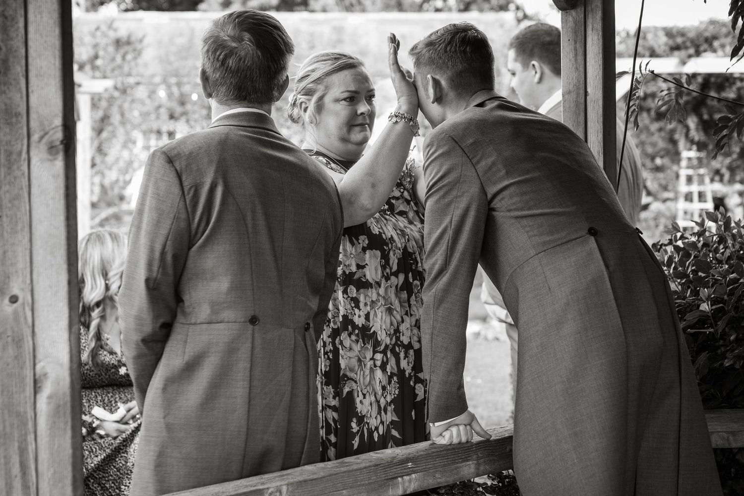 Group standing together in formal attire at an outdoor venue.