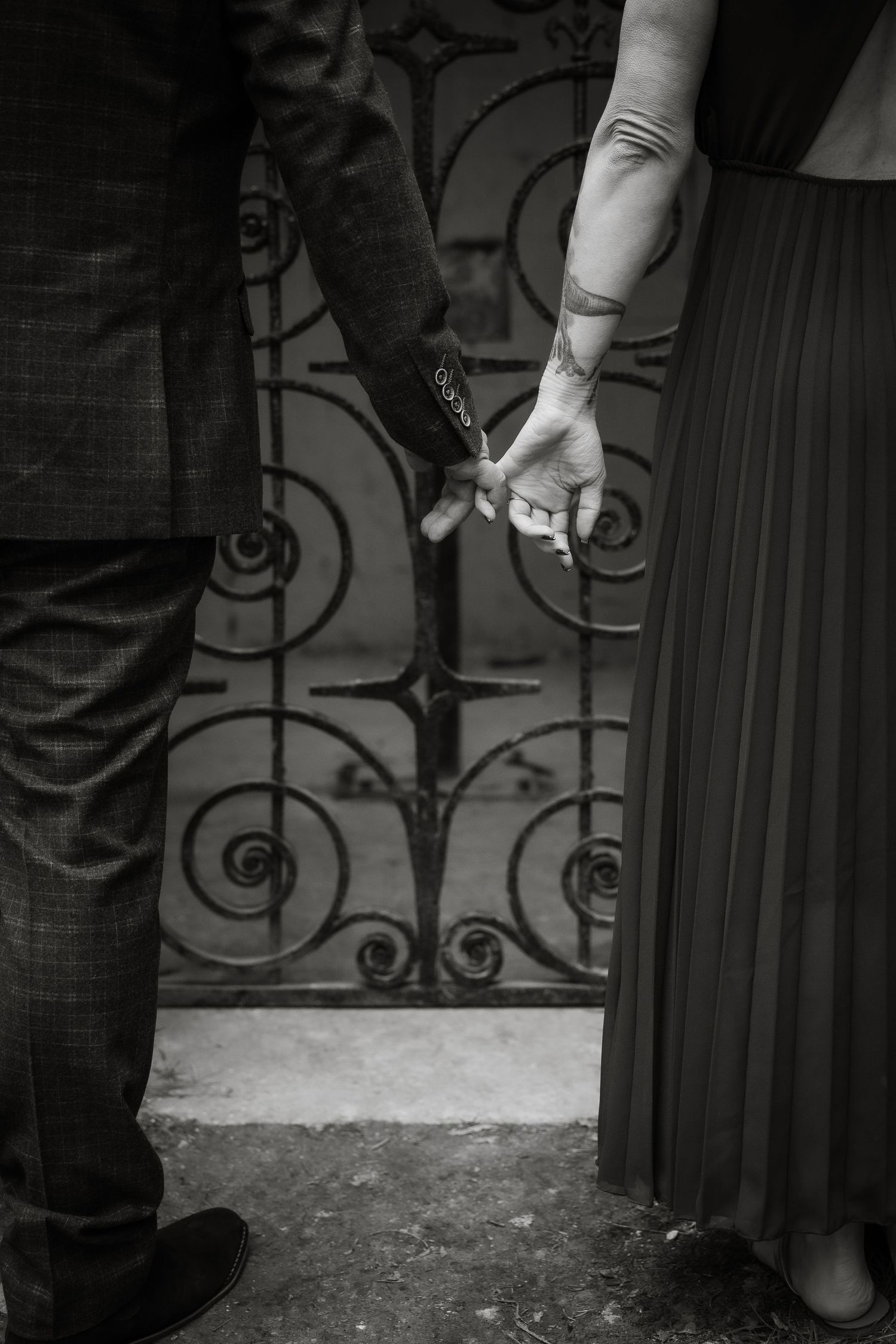A sequence of close-up shots showing someone's hand next to an ornate metal door or gate.