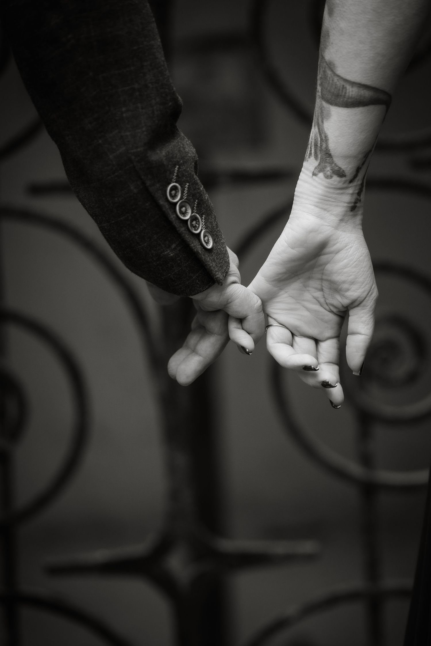 Black and white image sequence of hands holding a glowing object in darkness, creating a sense of mystery and connection.
