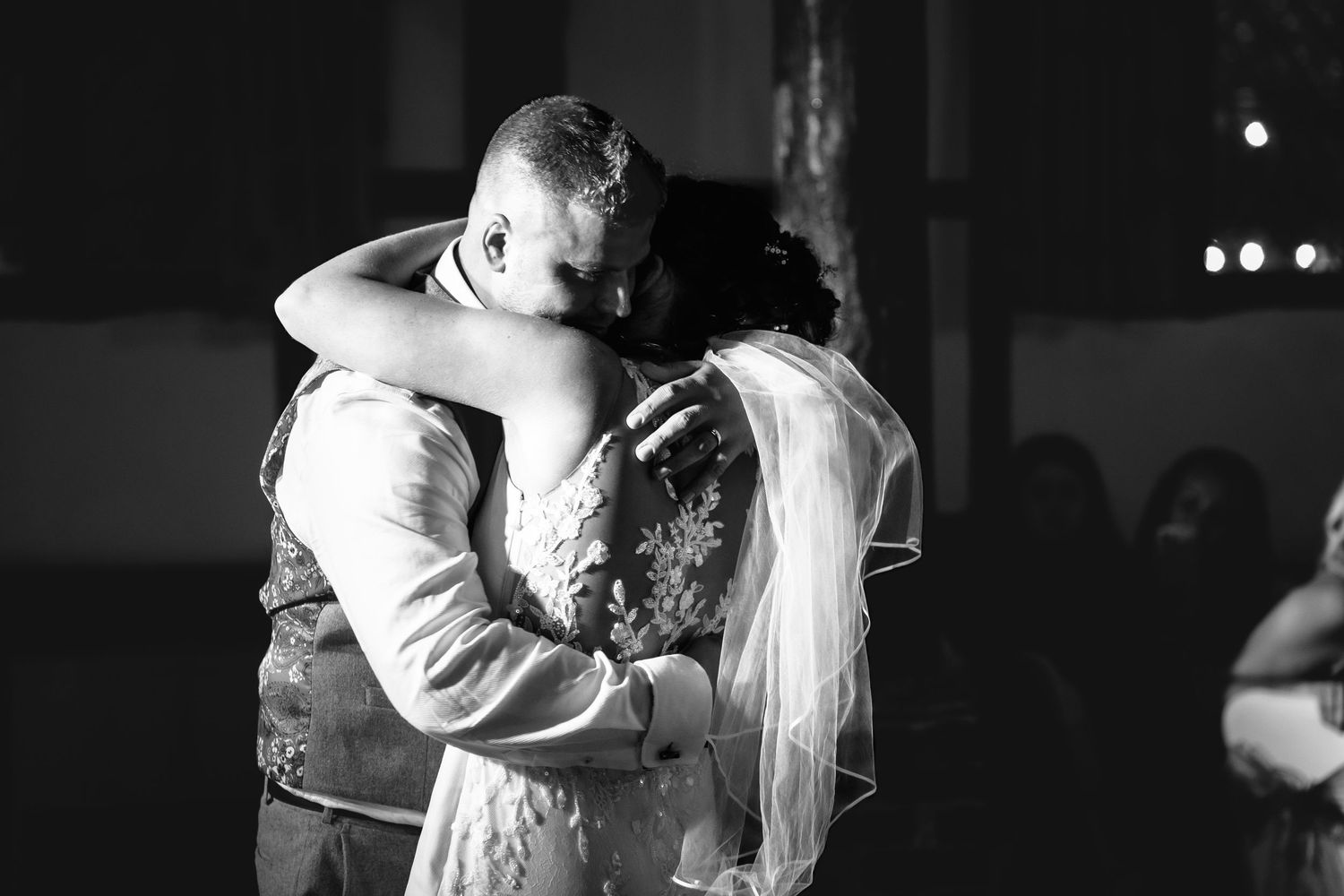 A tender black and white dancing moment captured during a wedding reception.