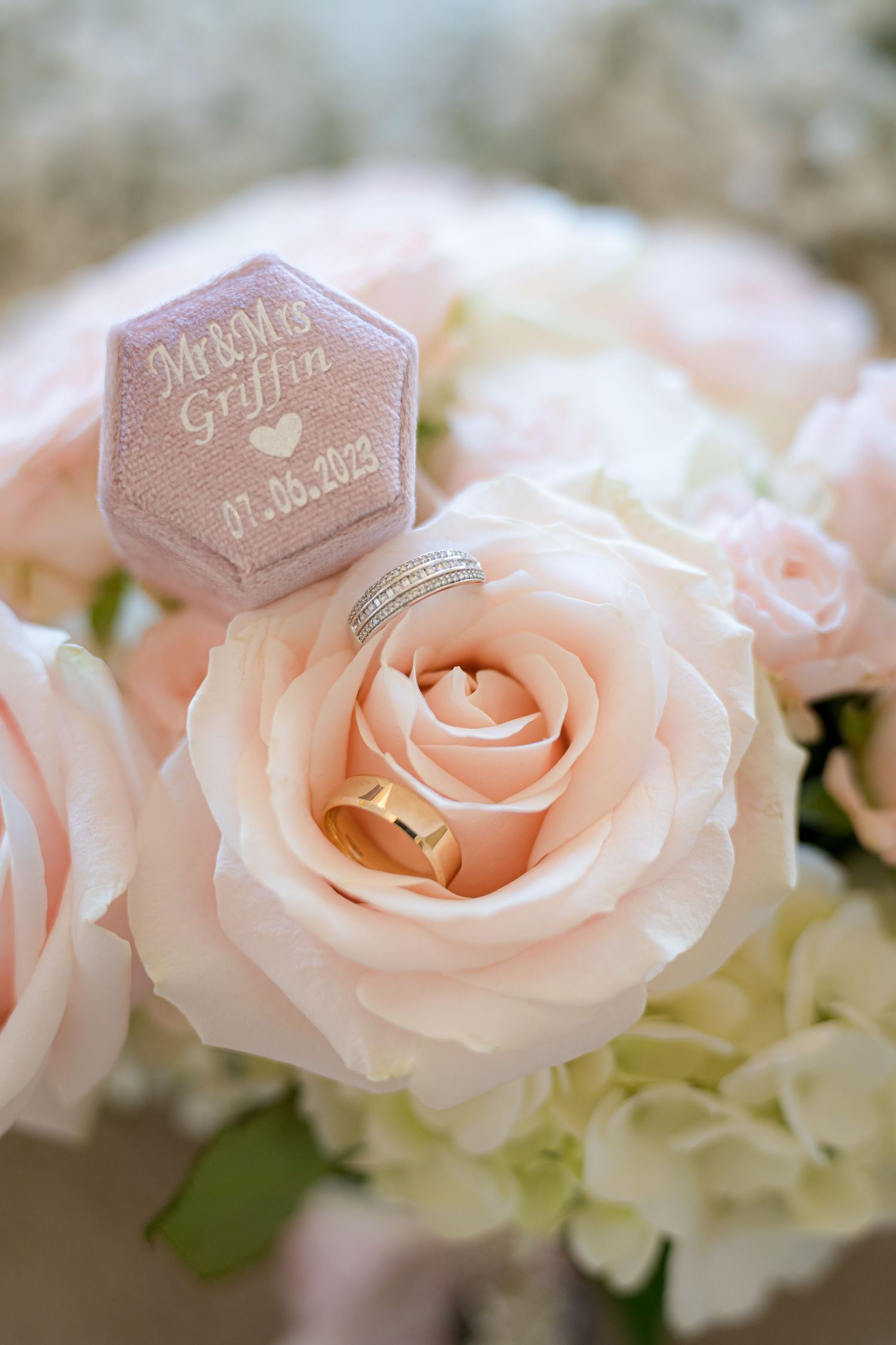 Close up of pink roses with a decorative hexagonal tag.
