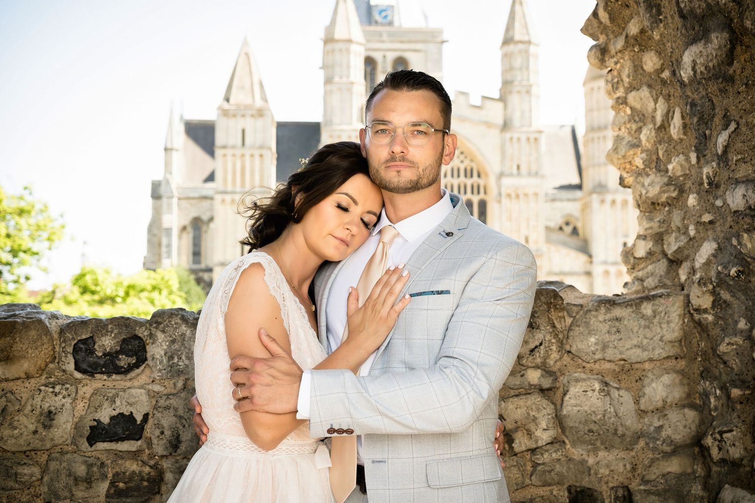 Romantic wedding photo captured against a historic castle backdrop.