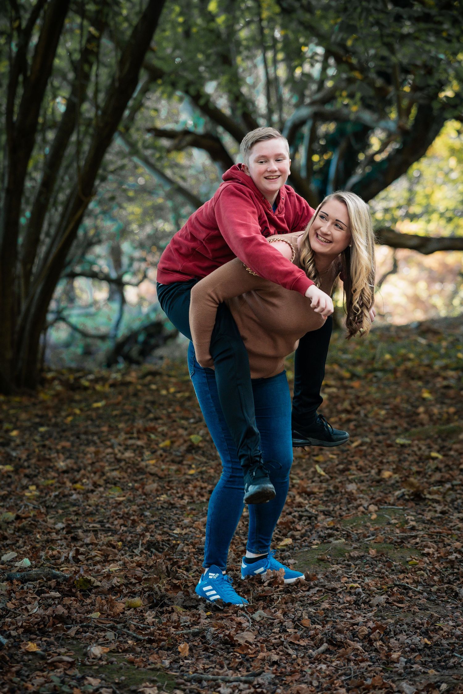 Candid moments of joy and laughter in an autumn forest setting.
