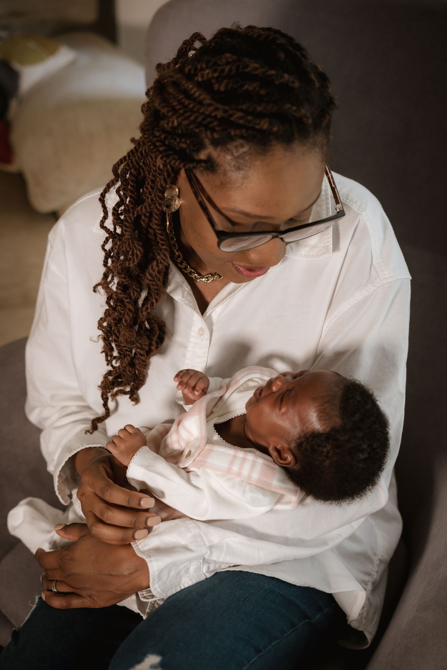 Tender moment of parent holding and gazing at newborn baby.