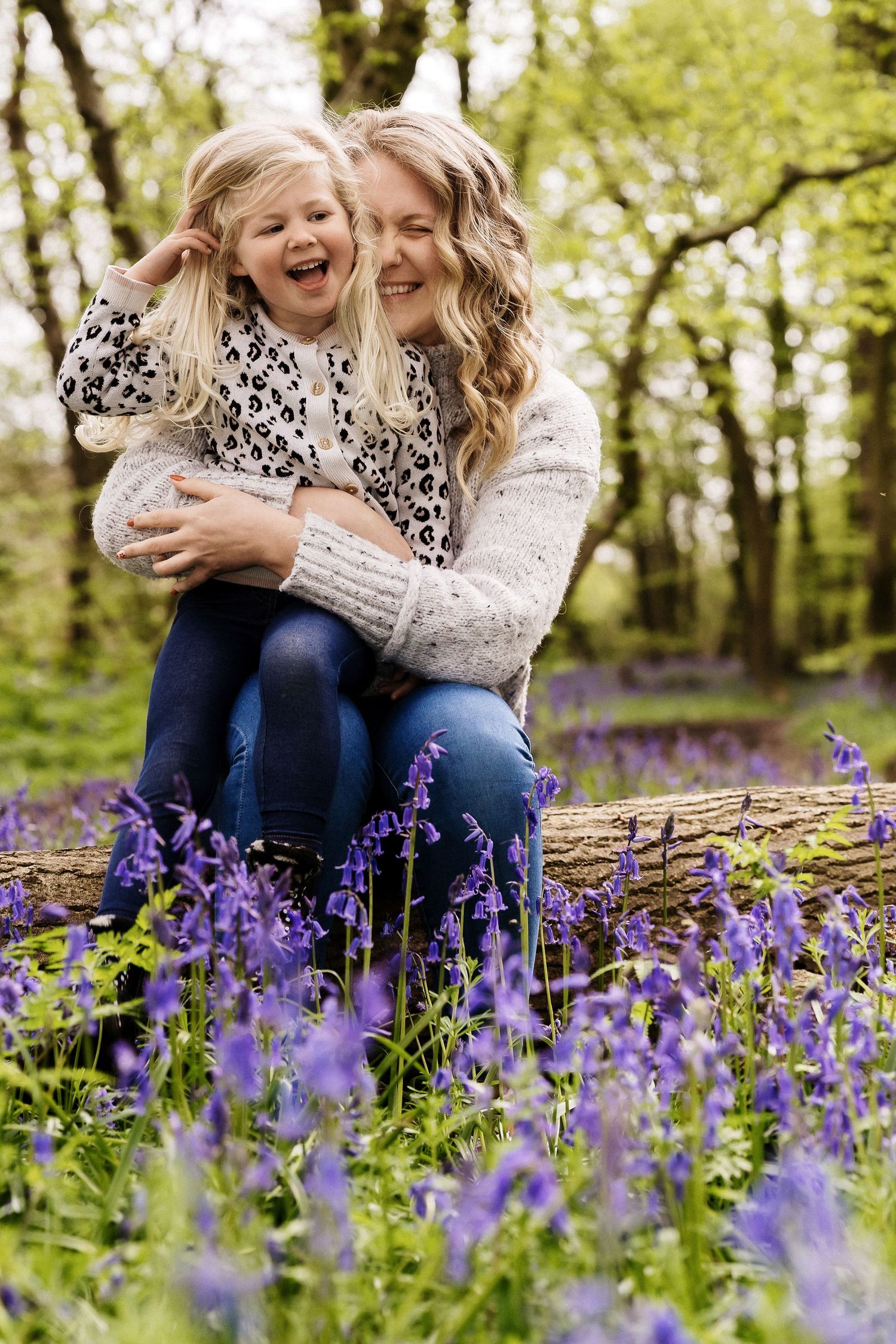 Joyful moment shared in blooming spring bluebell woods.
