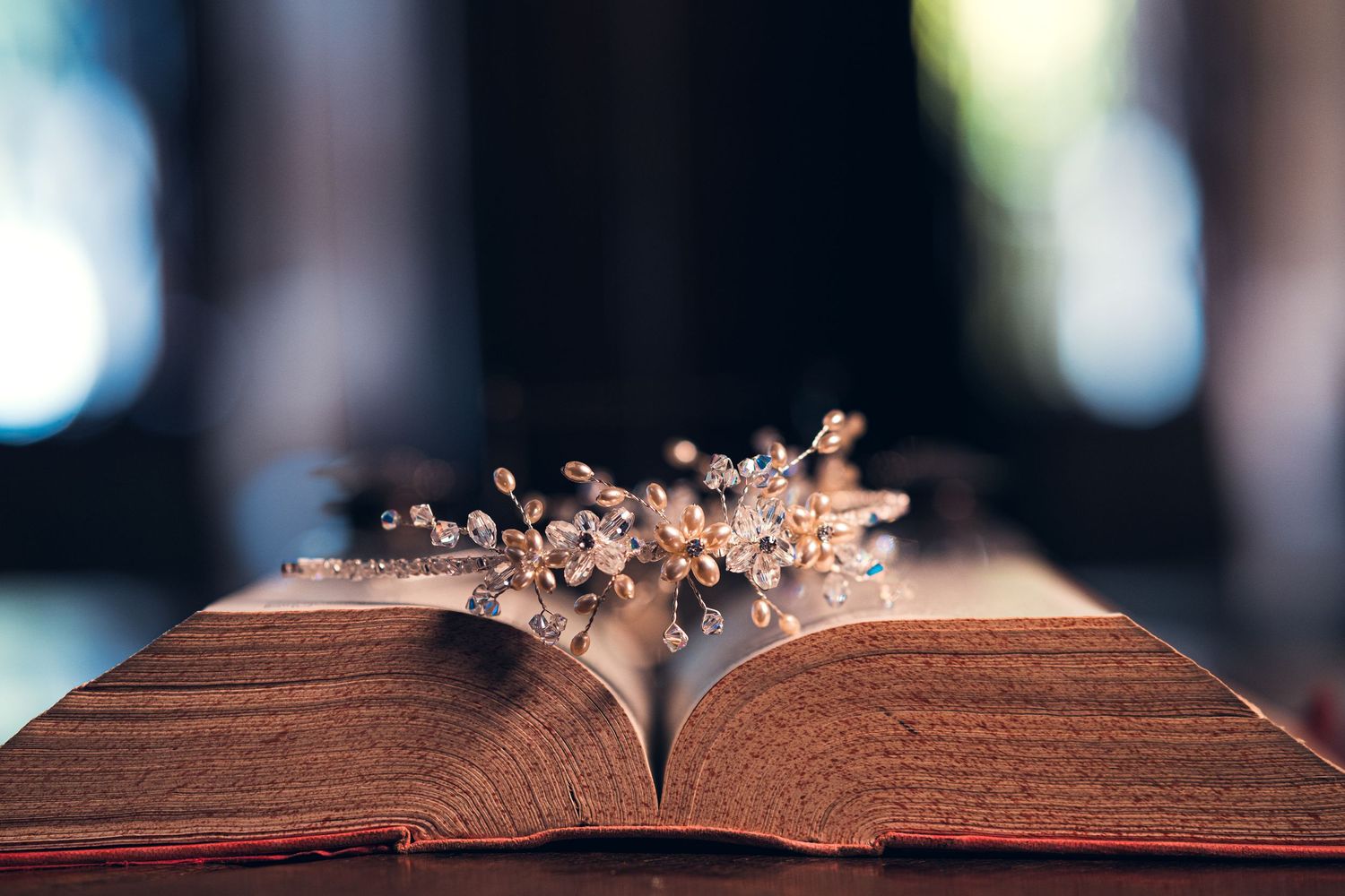 Rustic wooden table surface with delicate crystal details in soft focus.