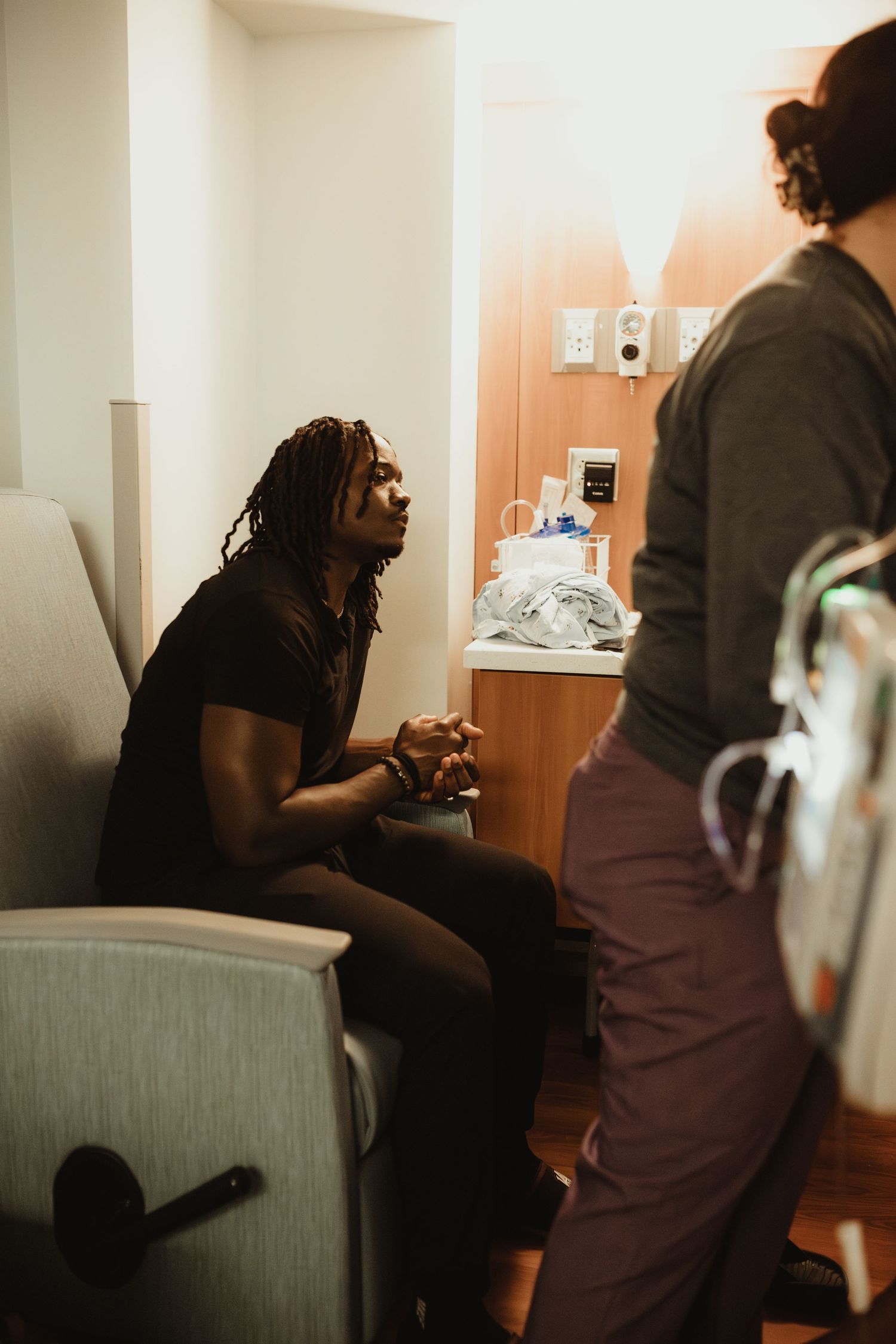 Medical professionals at work in an examination room are shown in a sequence of dark atmospheric photos.