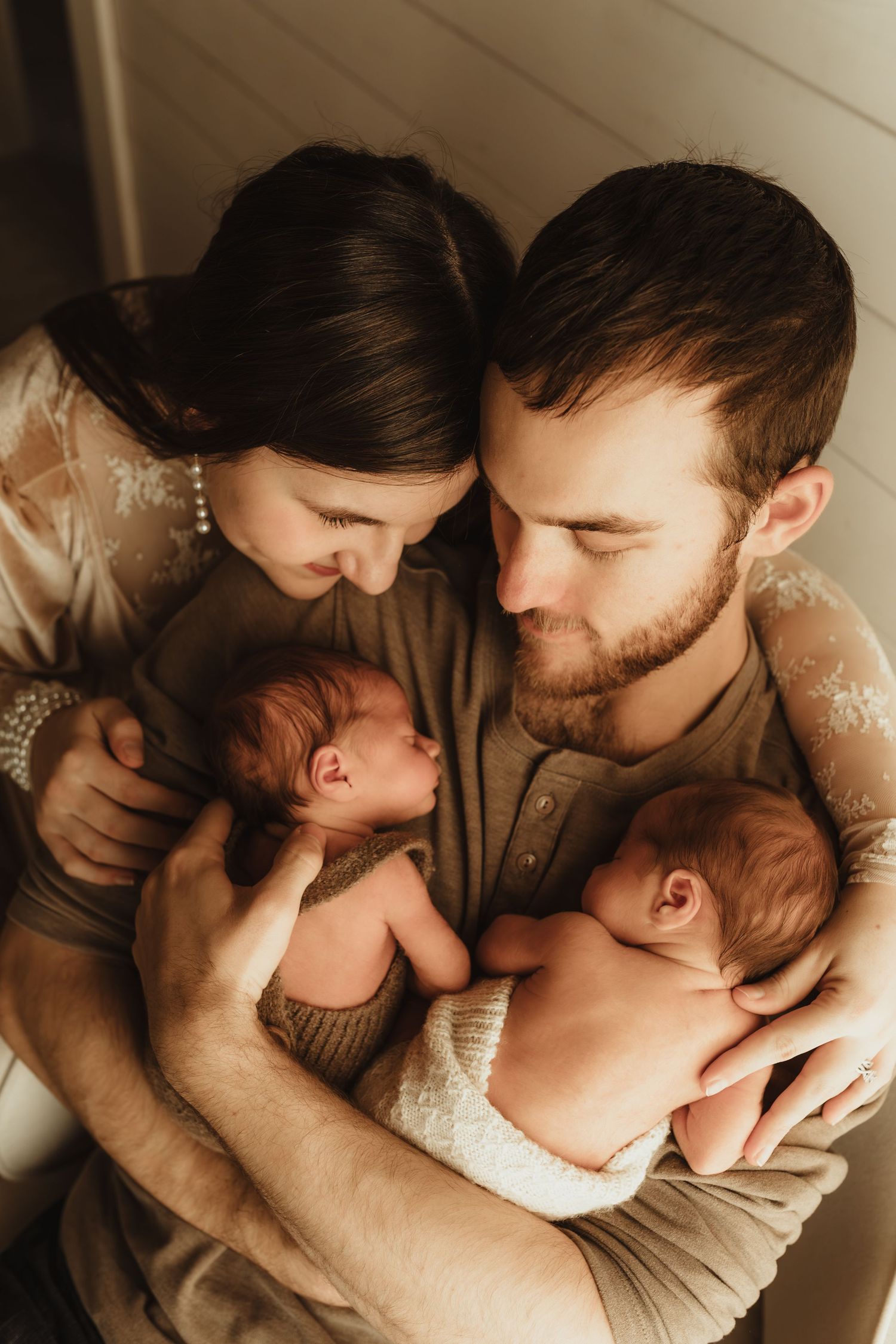 A series of intimate family photos showing tender moments between parents and their newborn baby in warm neutral tones.