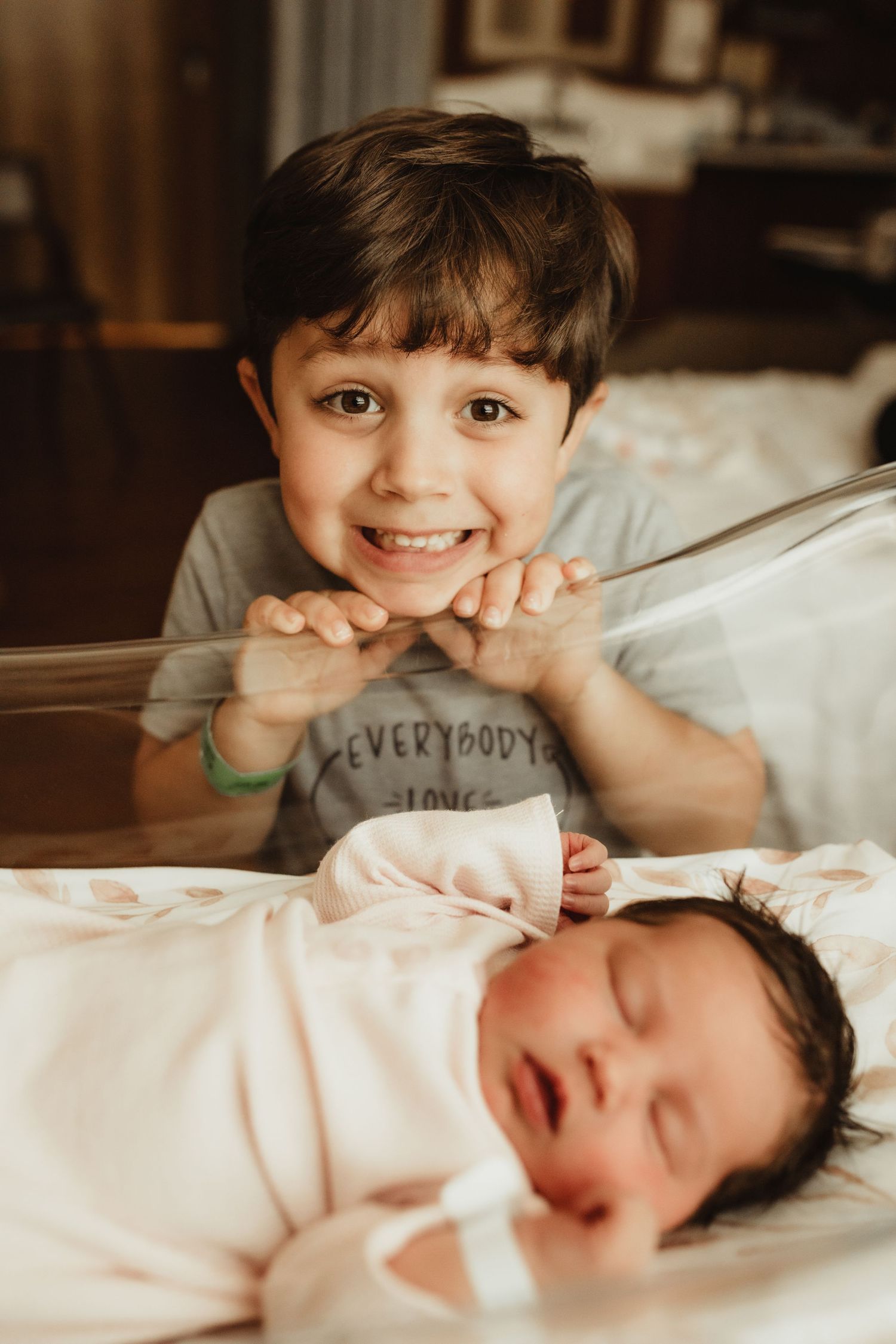 A heartwarming series of images showing siblings bonding together while laying on white bedding.