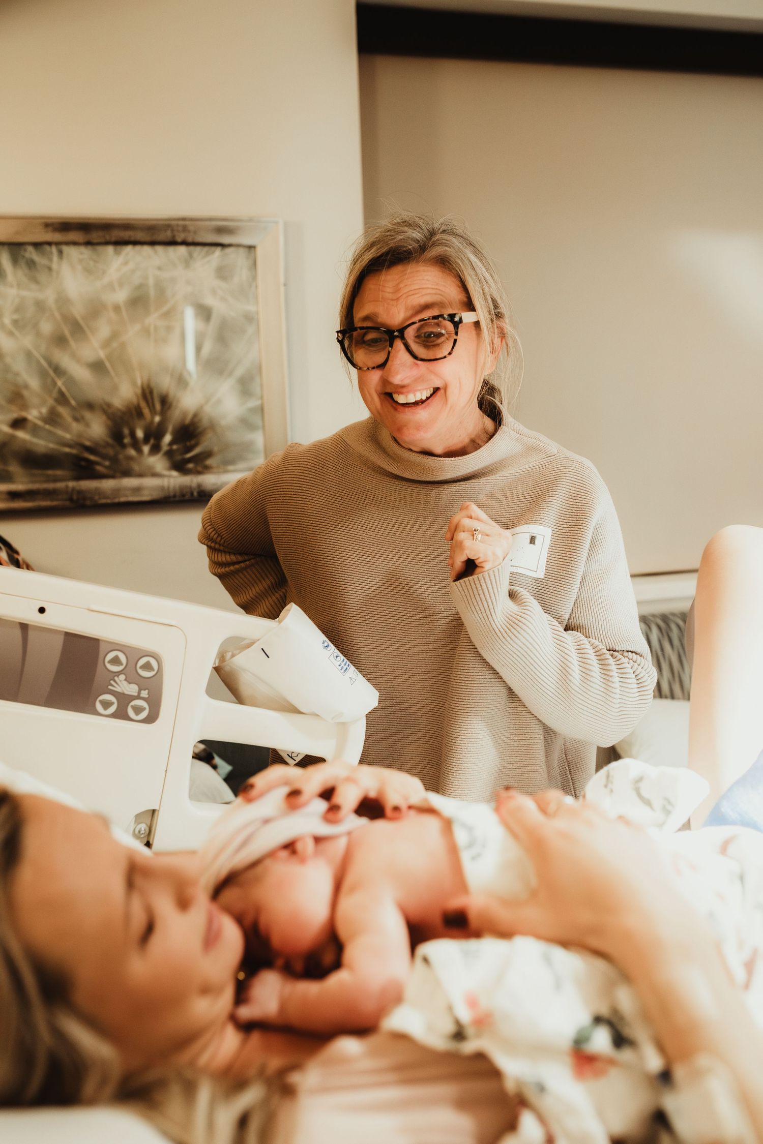 Professional using ultrasound equipment to examine a newborn baby in a medical setting.