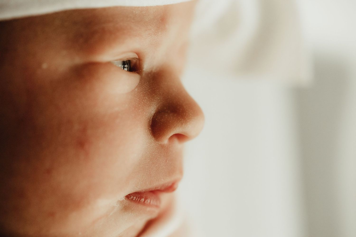 Close-up macro photo of a child's nose and lips in soft focus against a blurred background.