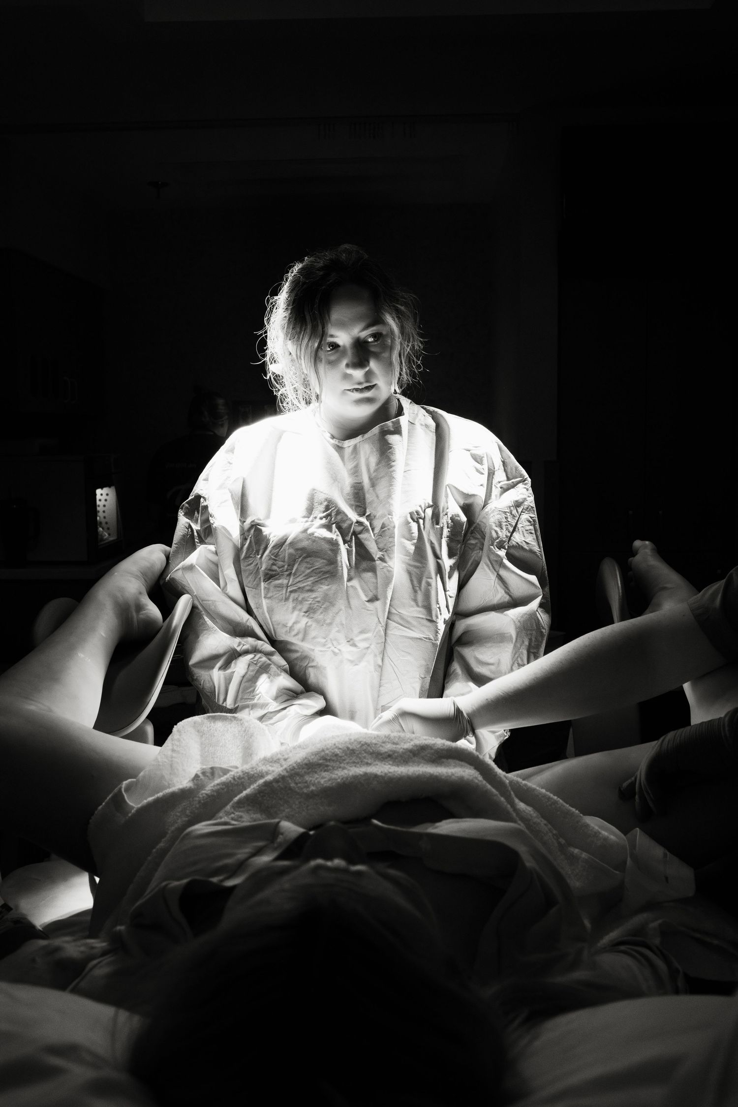 High contrast black and white sequence showing a person sitting in bed at night looking at illuminated phone screen.