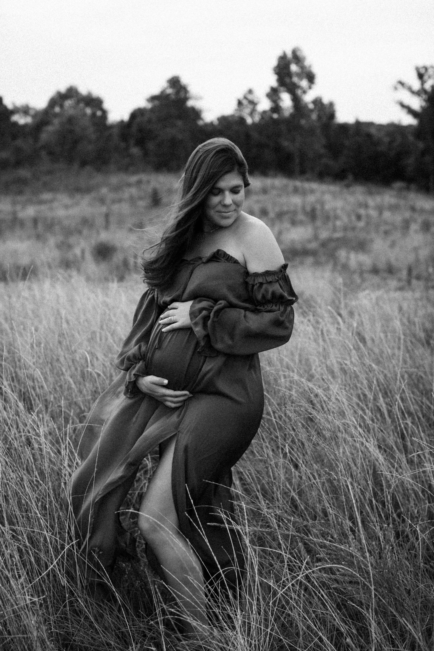 Black and white photo series showing a person in a dark coat laughing and posing expressively in tall grass outdoors.