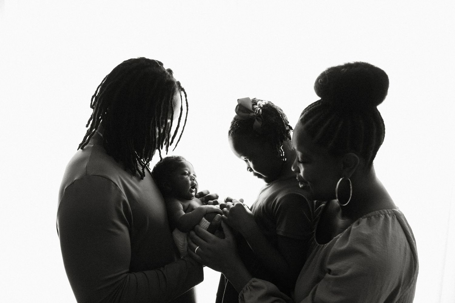 Silhouette of a family gathered together in an intimate moment.