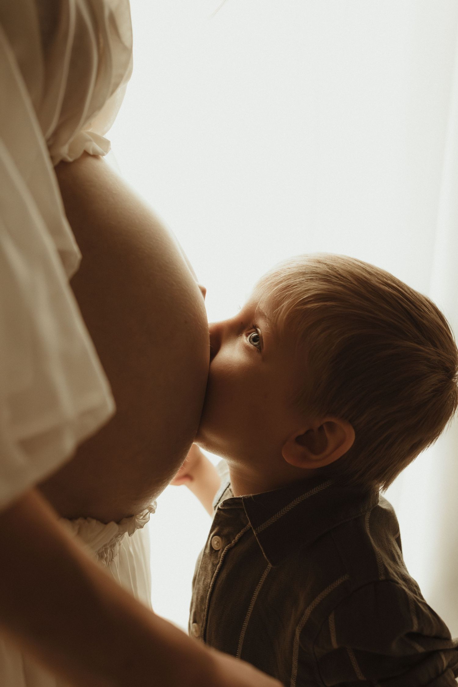 A sequence of silhouetted breastfeeding images shown in a progressive strip format against a bright white backdrop.