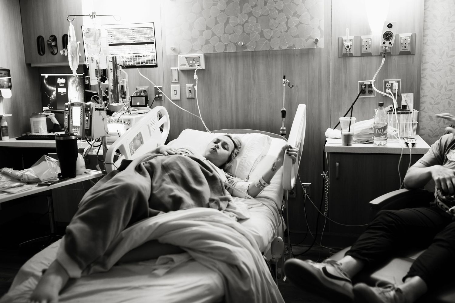 Black and white film photo series showing five different hospital patients sleeping in medical beds.