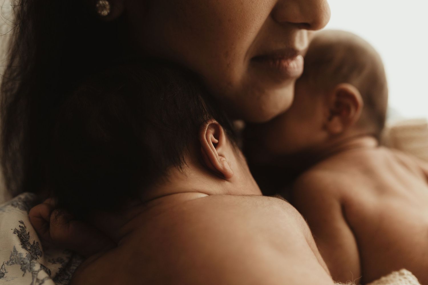 Artistic close-up family portraits with dramatic light and shadow play.