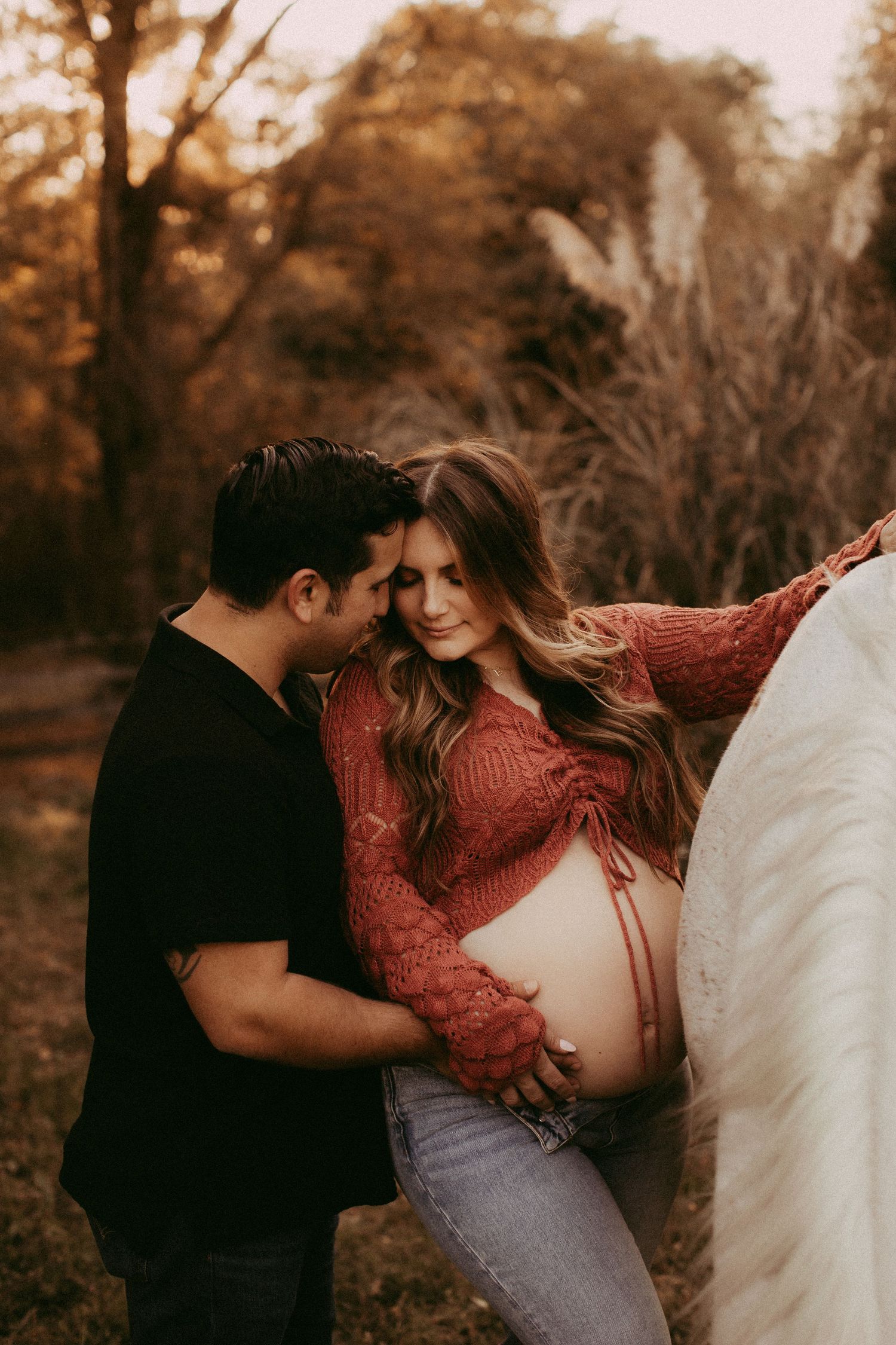 Sepia-toned maternity photo shoot sequence showing intimate moments between couple outdoors at sunset.