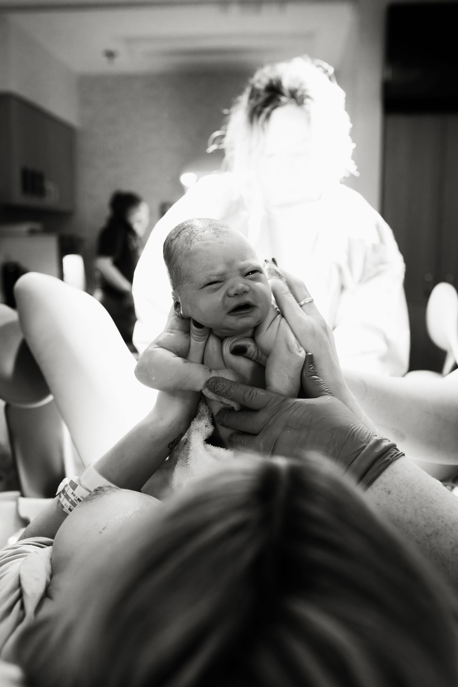 Black and white candid photos show emotional expressions and laughter at an intimate gathering.