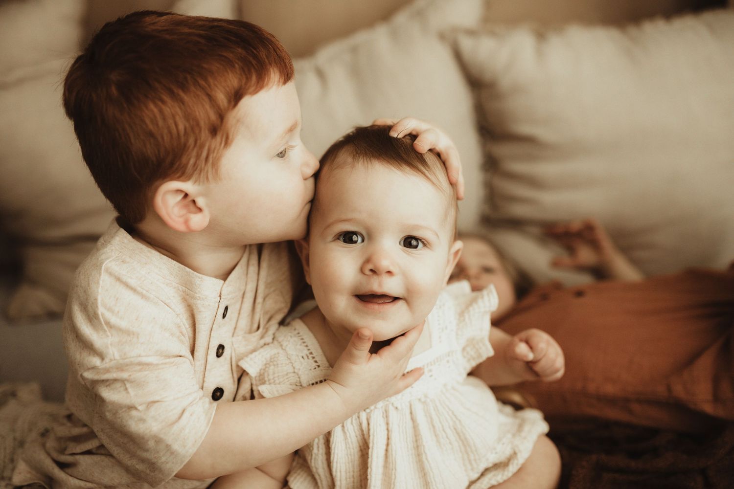 A heartwarming sequence of sibling interactions showing tender moments of affection and play in warm sepia tones.