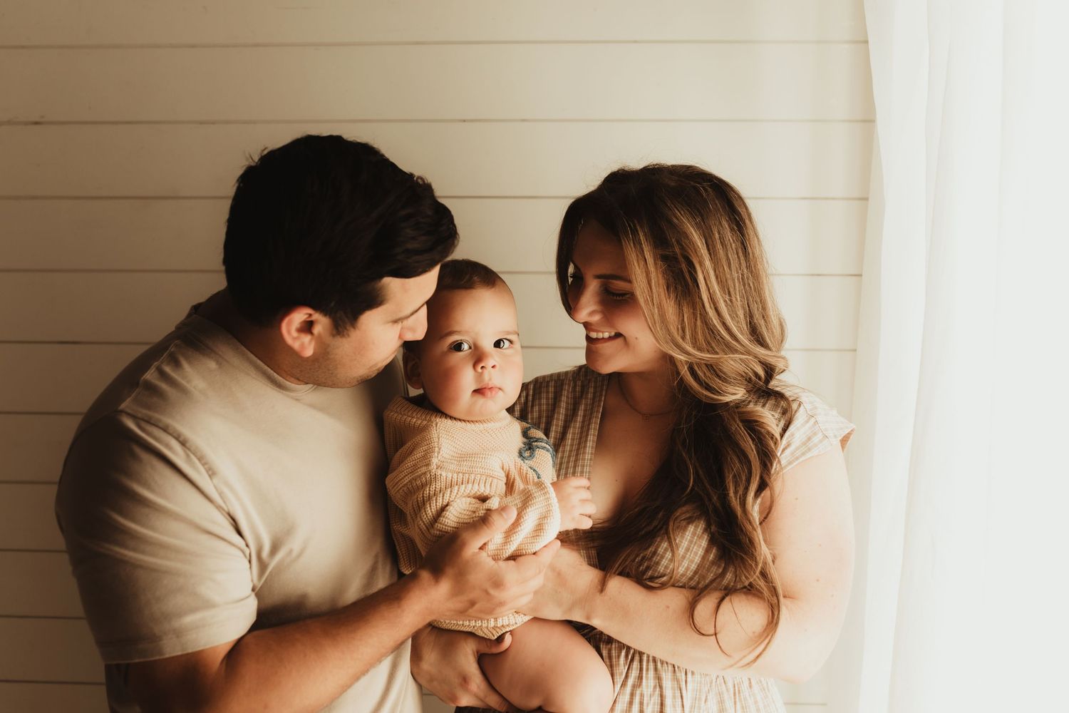 A loving family shares tender moments together in a series of intimate black and white photographs.