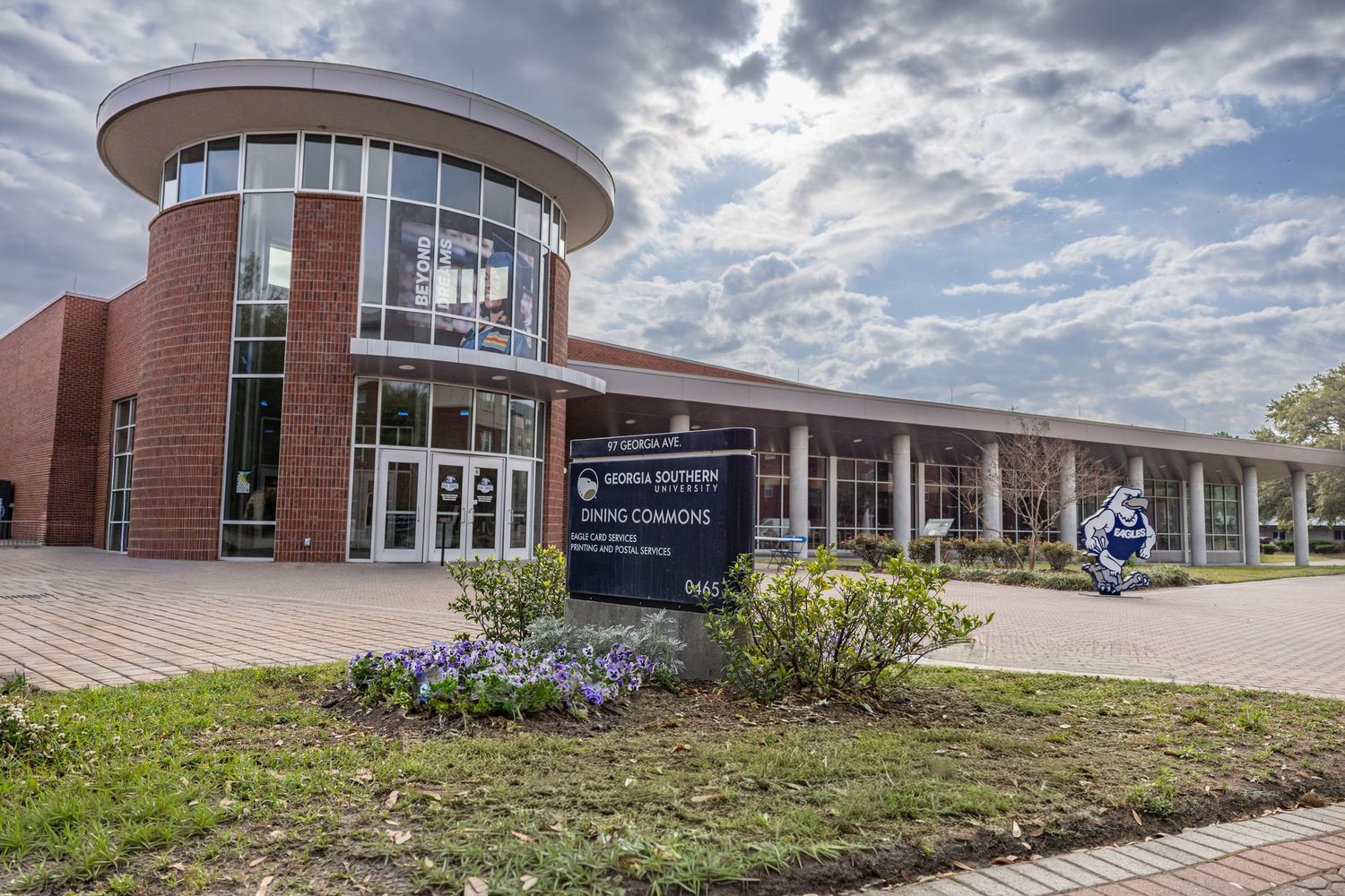 Exterior view of Georgia Southern University Dining Commons building on a partly cloudy day.