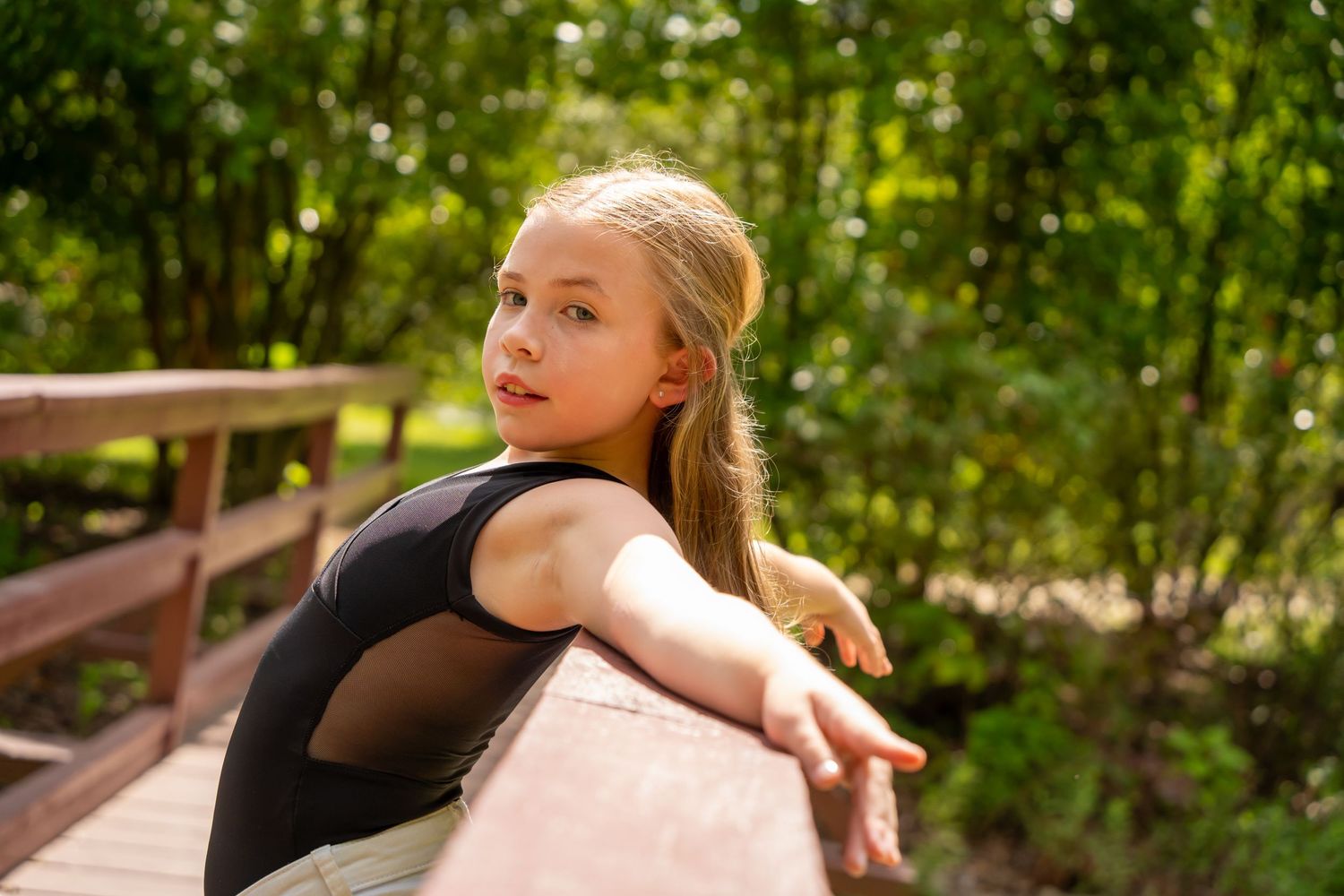 Artistic outdoor portrait series with natural greenery backdrop.