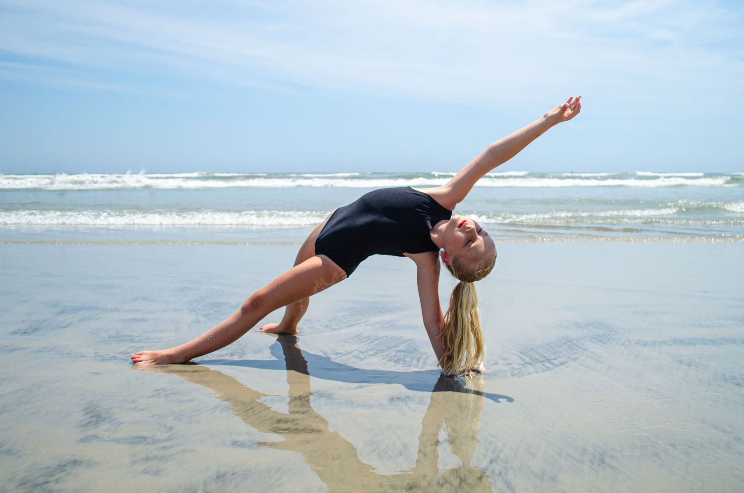 Dynamic poses captured on a sandy beach with ocean waves in the background.