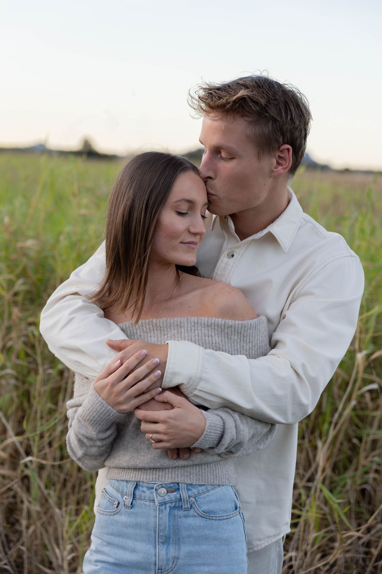 Couple photos at a grassy field.