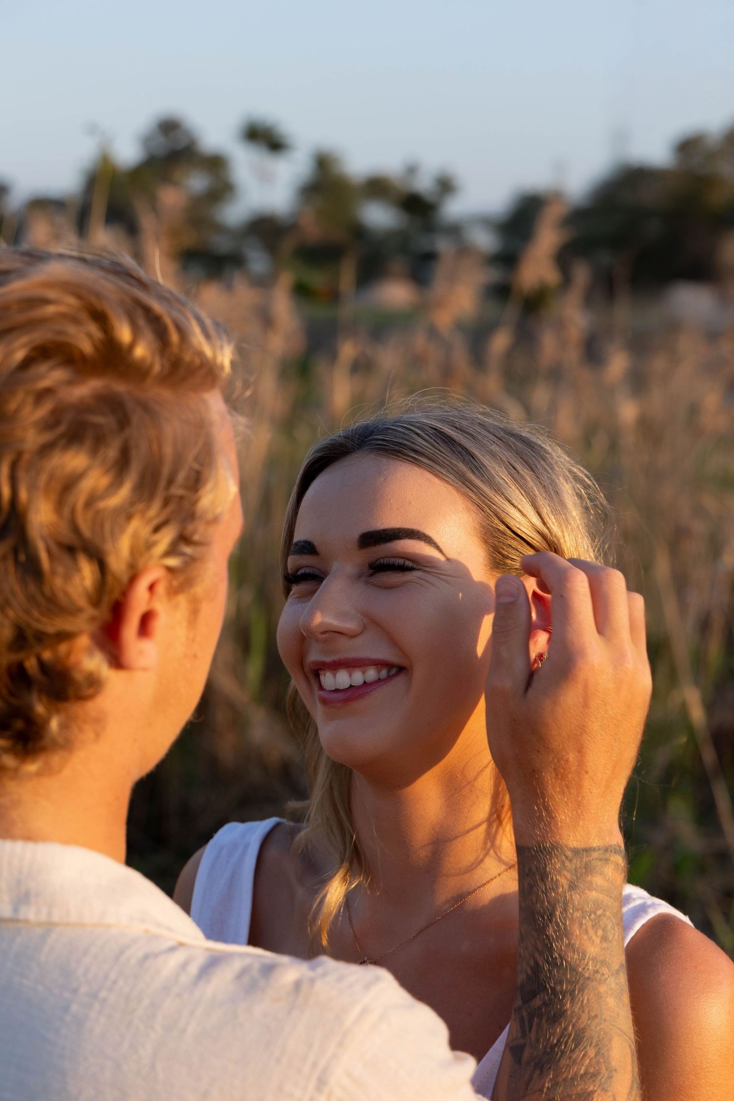 Engagement photos in a field.