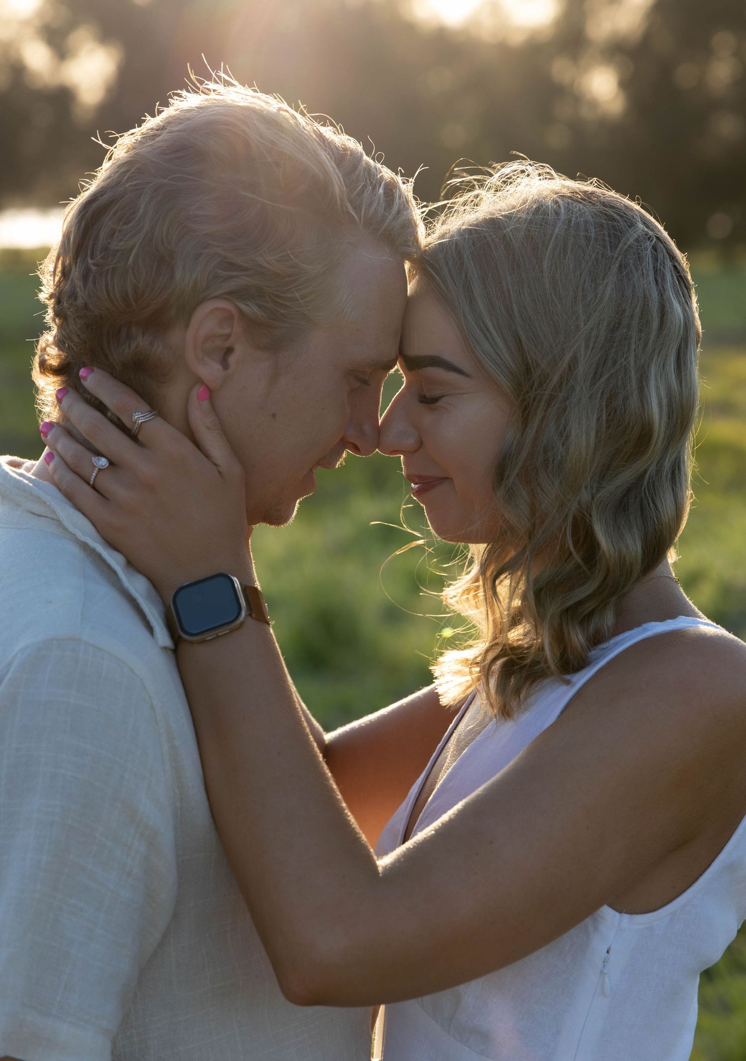 Engagement photos in a field.
