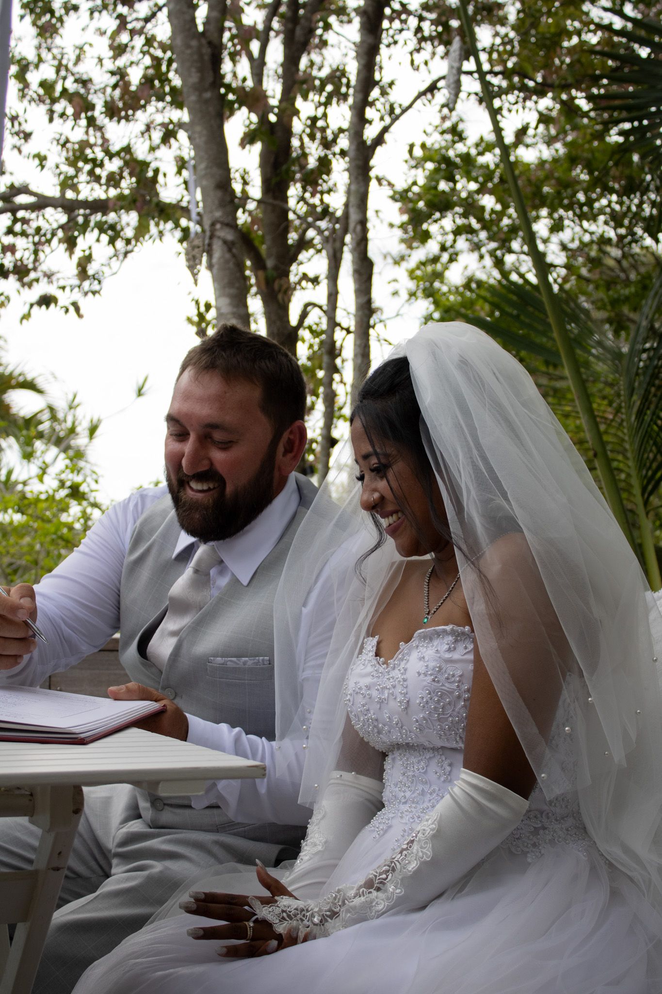 Couple signing their marriage photos.