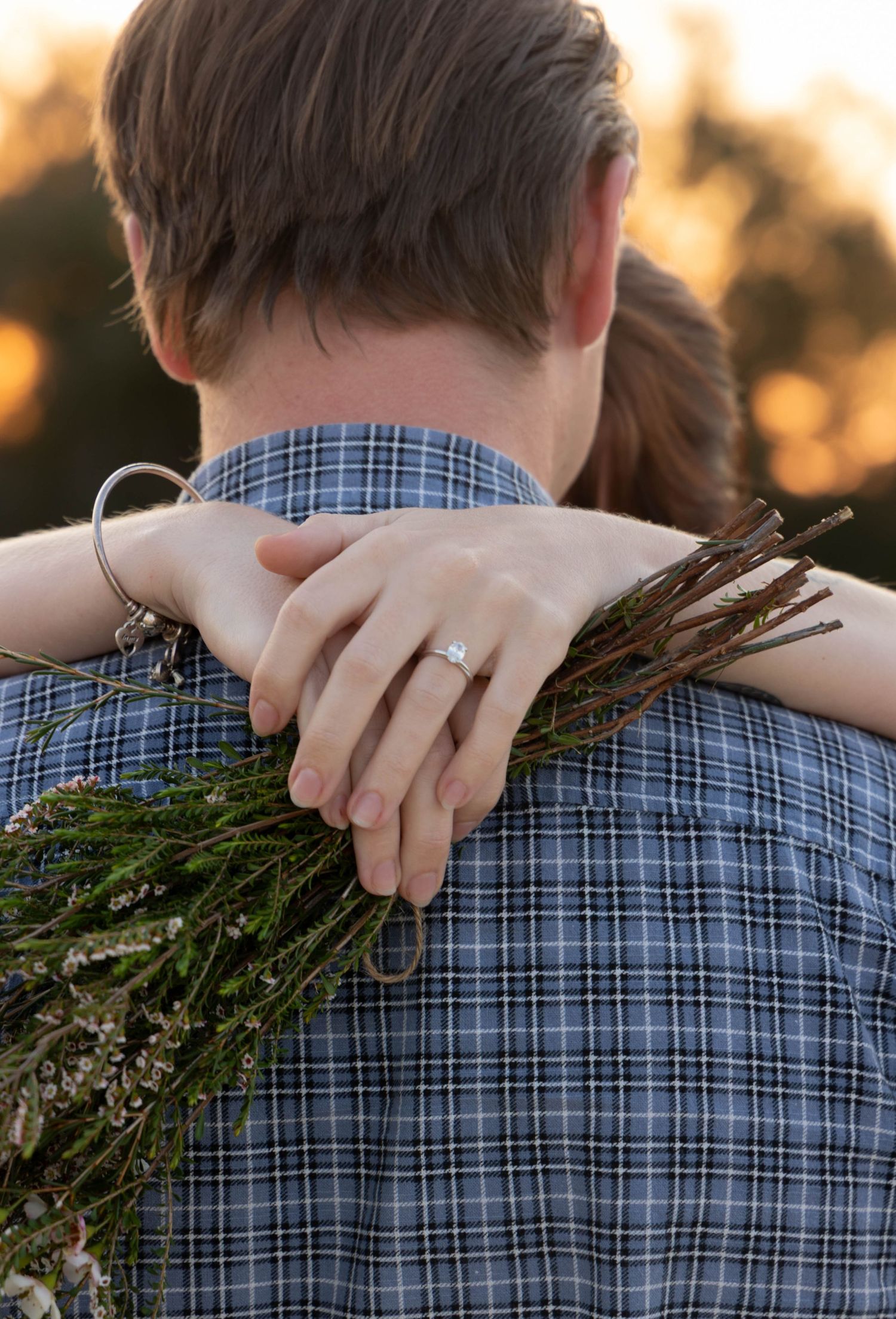 Engagement photos in a field with flowers.