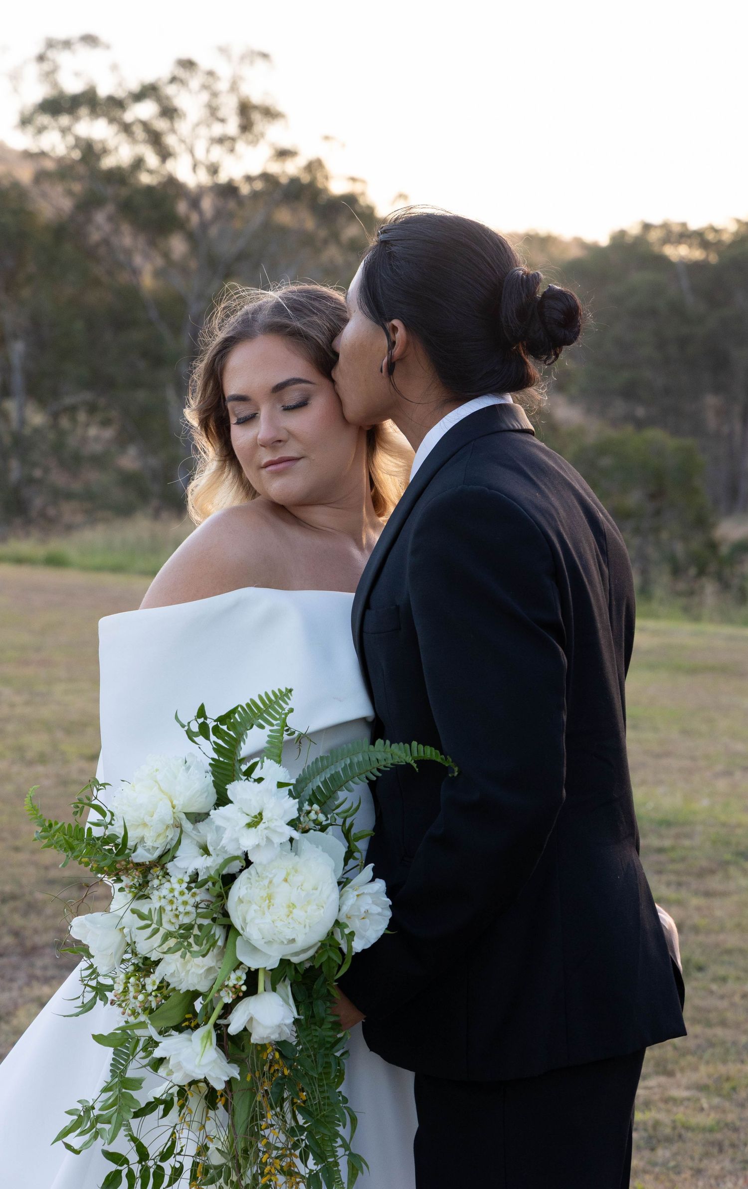 Shows a couple posing for their wedding photos.