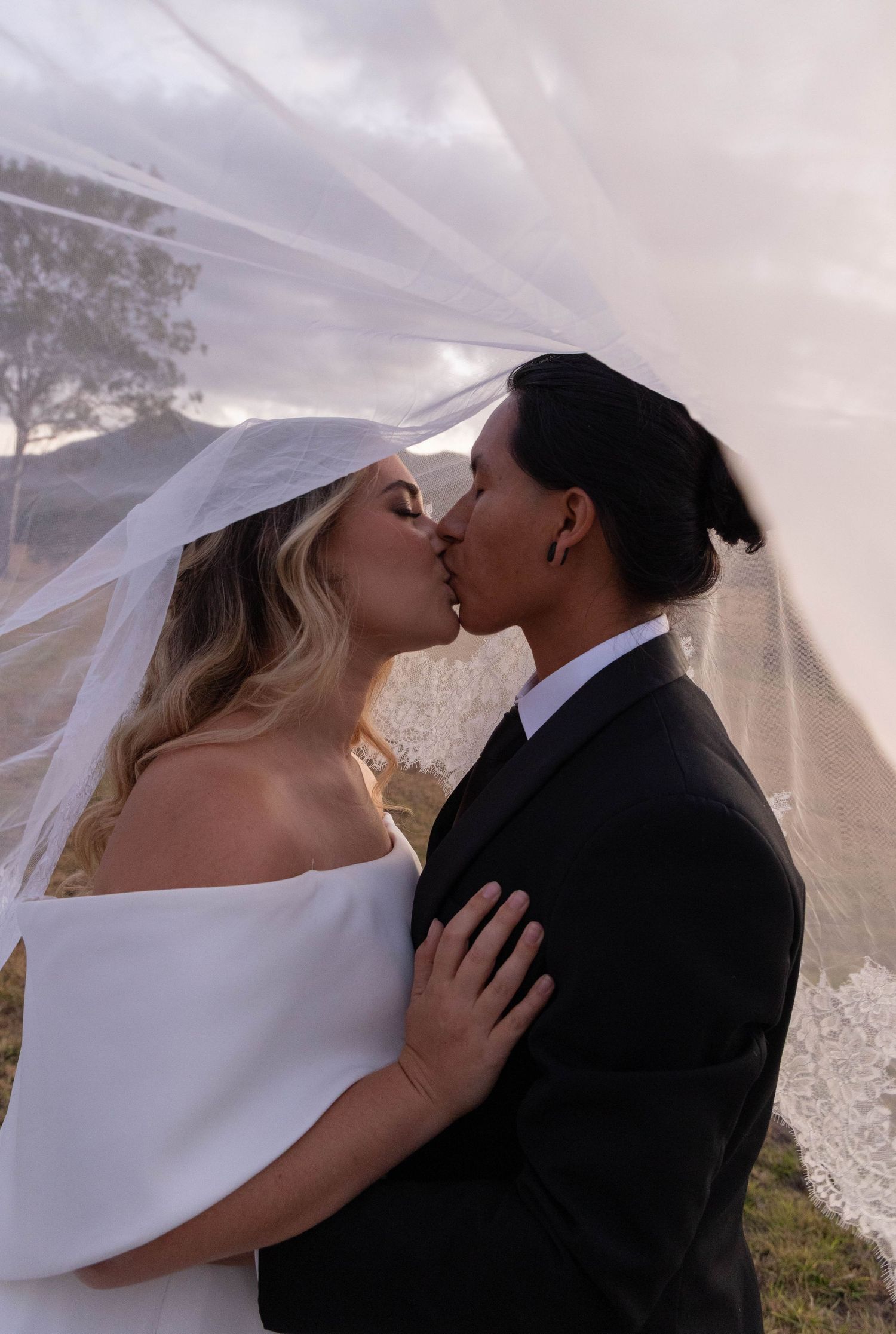 Couple getting photos under the veil.