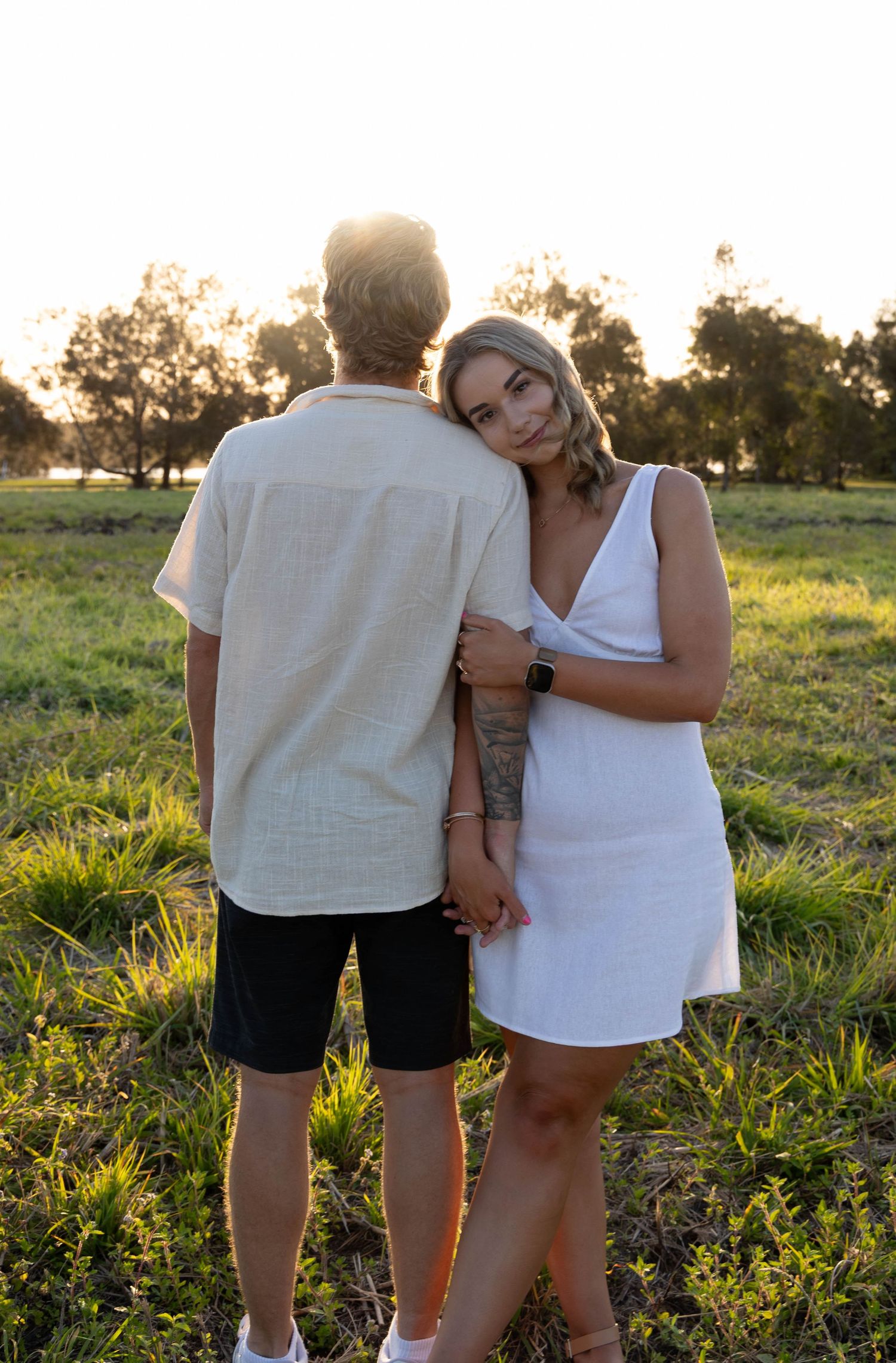 Engagement photos in a field.