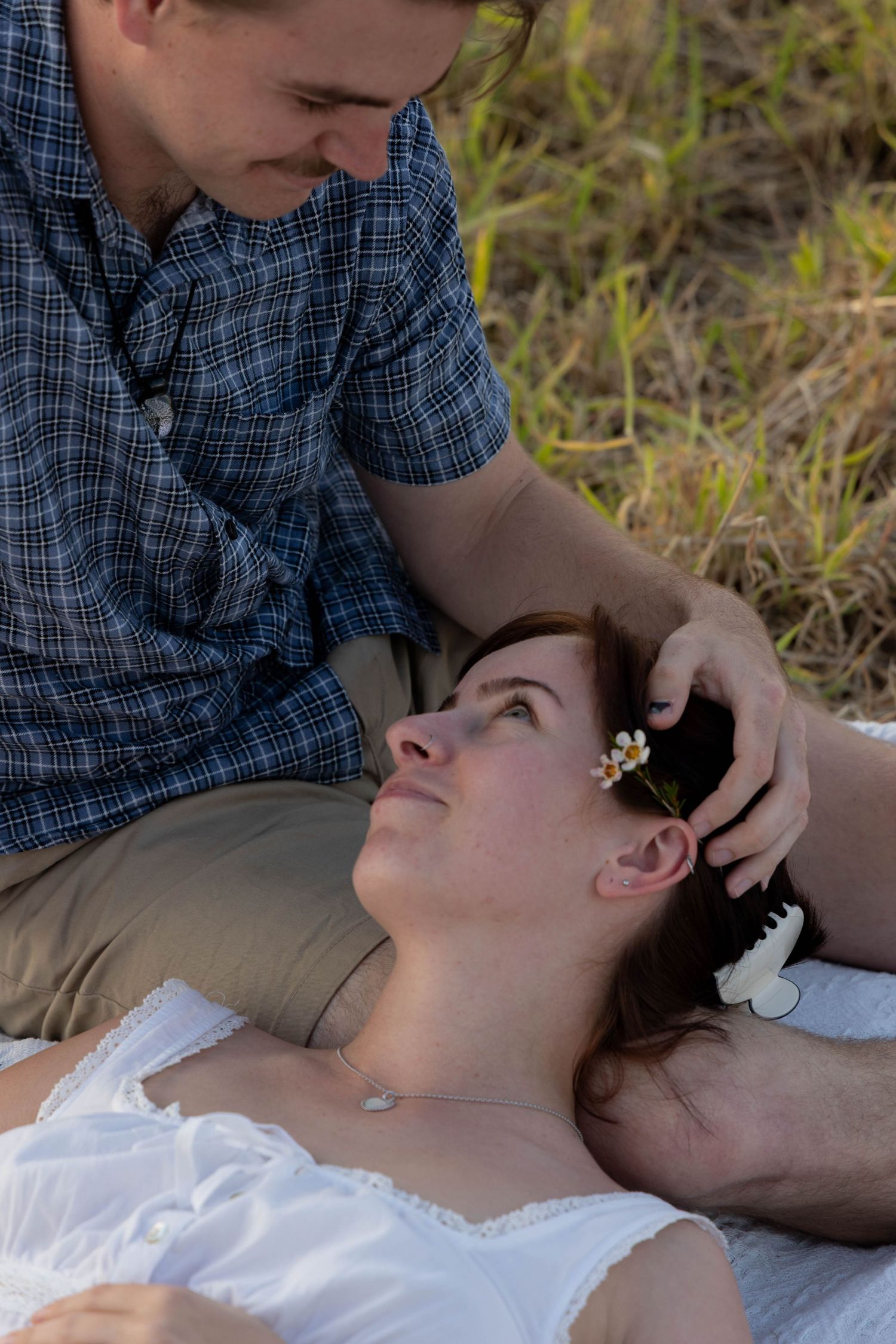 Engagement photos in a field.