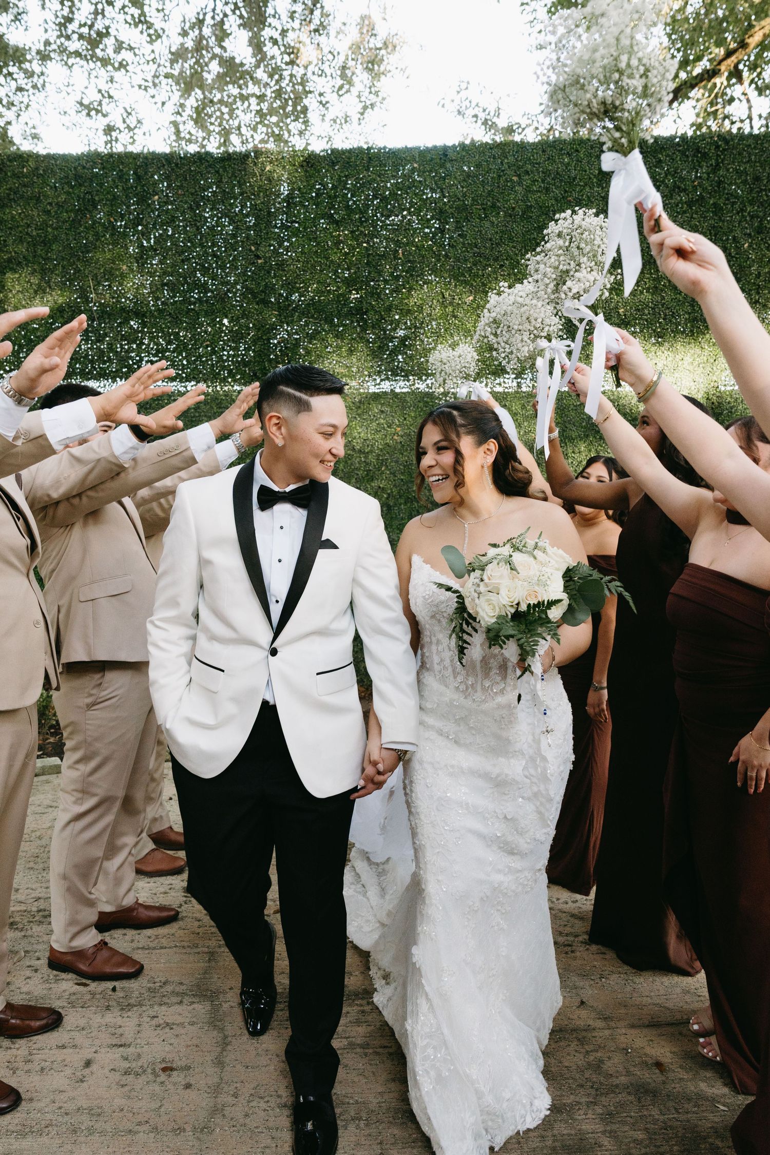 Wedding party celebrates with champagne spraying outdoors in a fun candid sequence of photos.