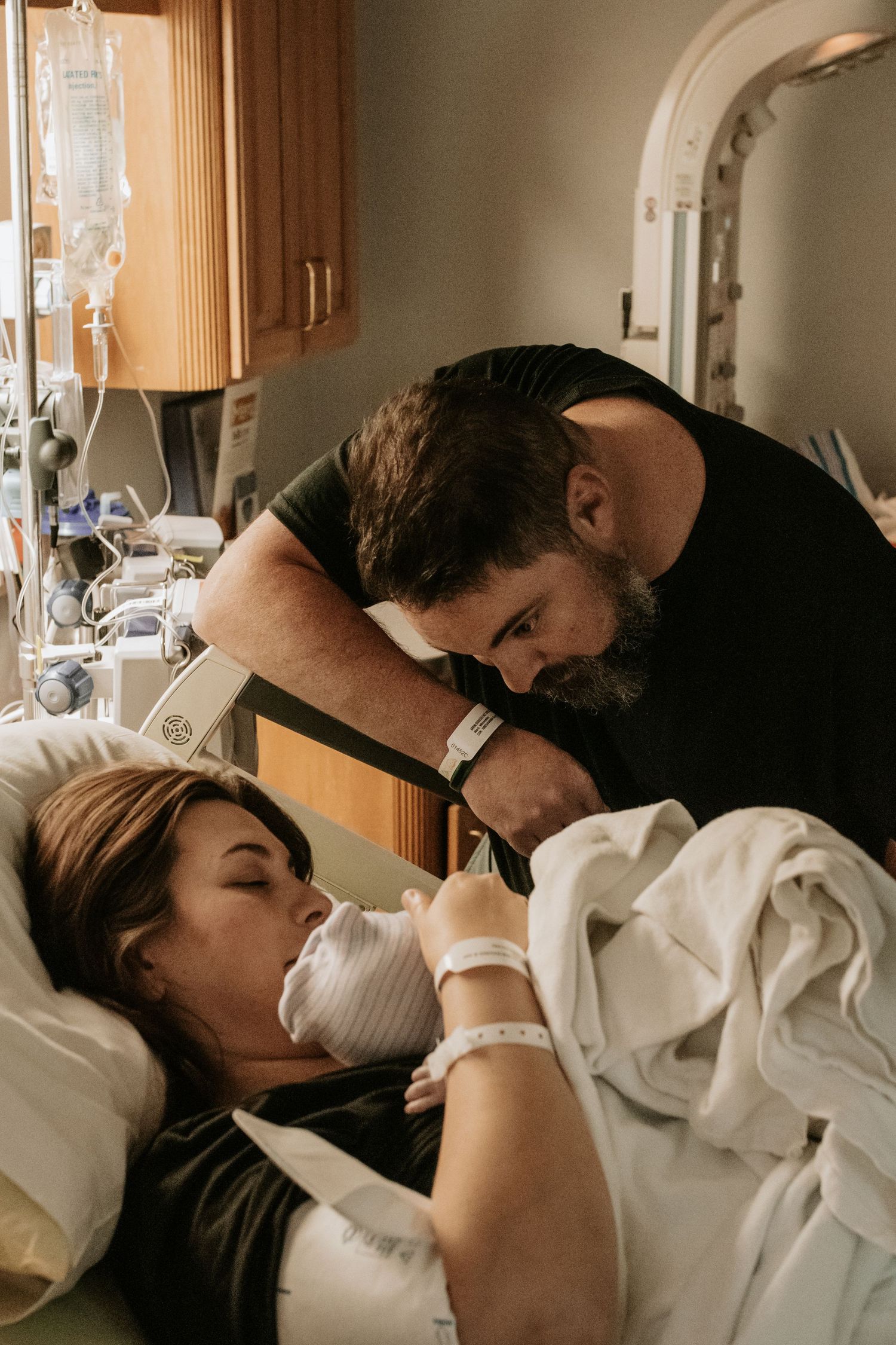 Emotional hospital room scene with medical equipment visible.